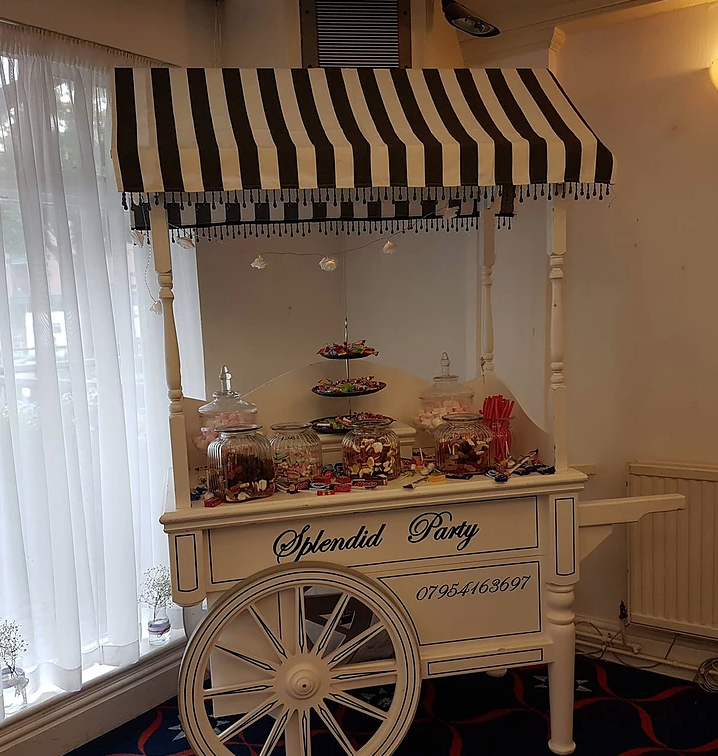 Candy cart with striped canopy at Spinnaker Function Suite for weddings and parties.
