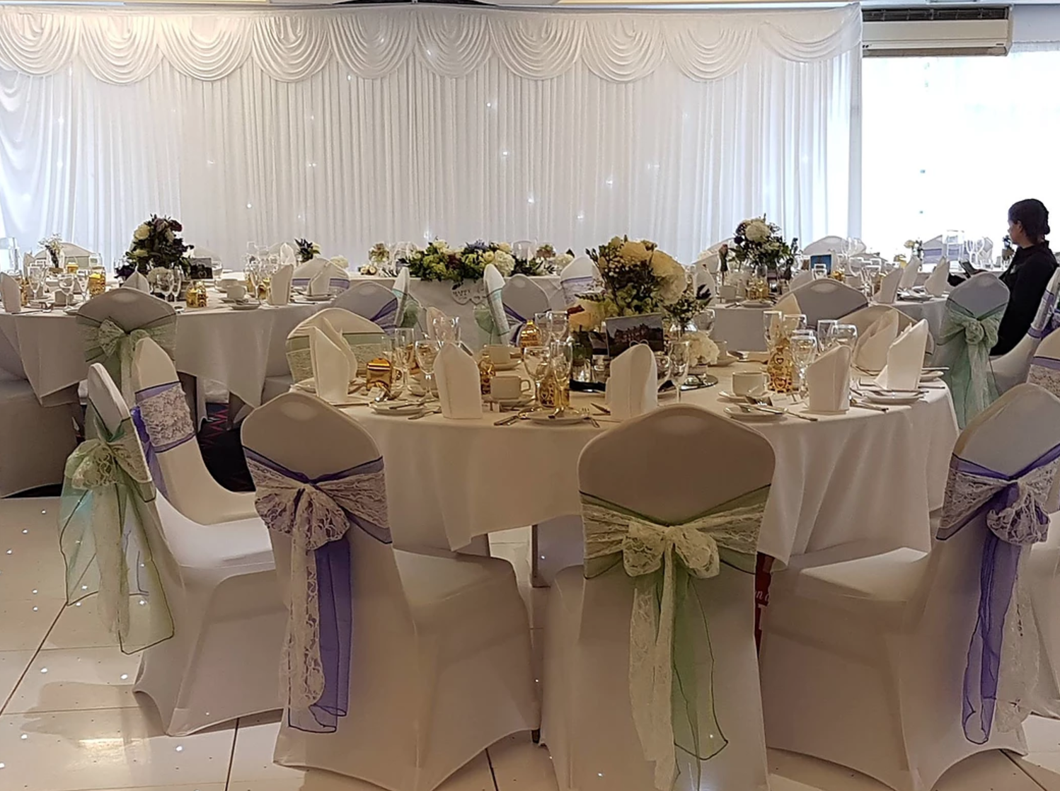 Elegant banquet hall with floral centerpieces, ideal for weddings and formal events.