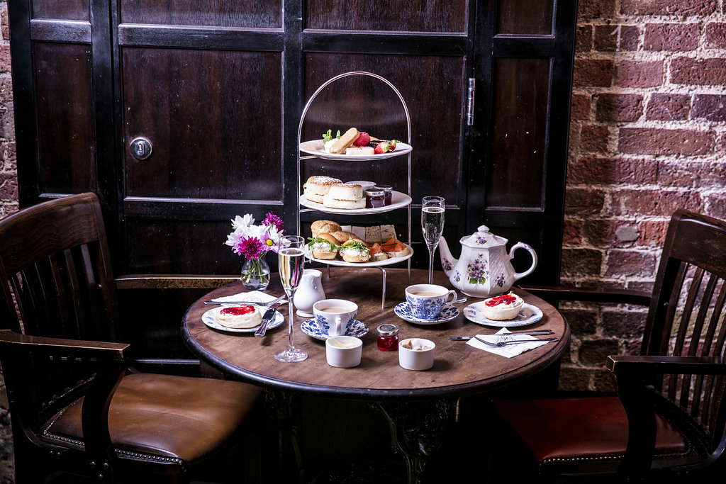 Elegant afternoon tea setup with pastries in Crusting Pipe, Covent Garden. Perfect for events.