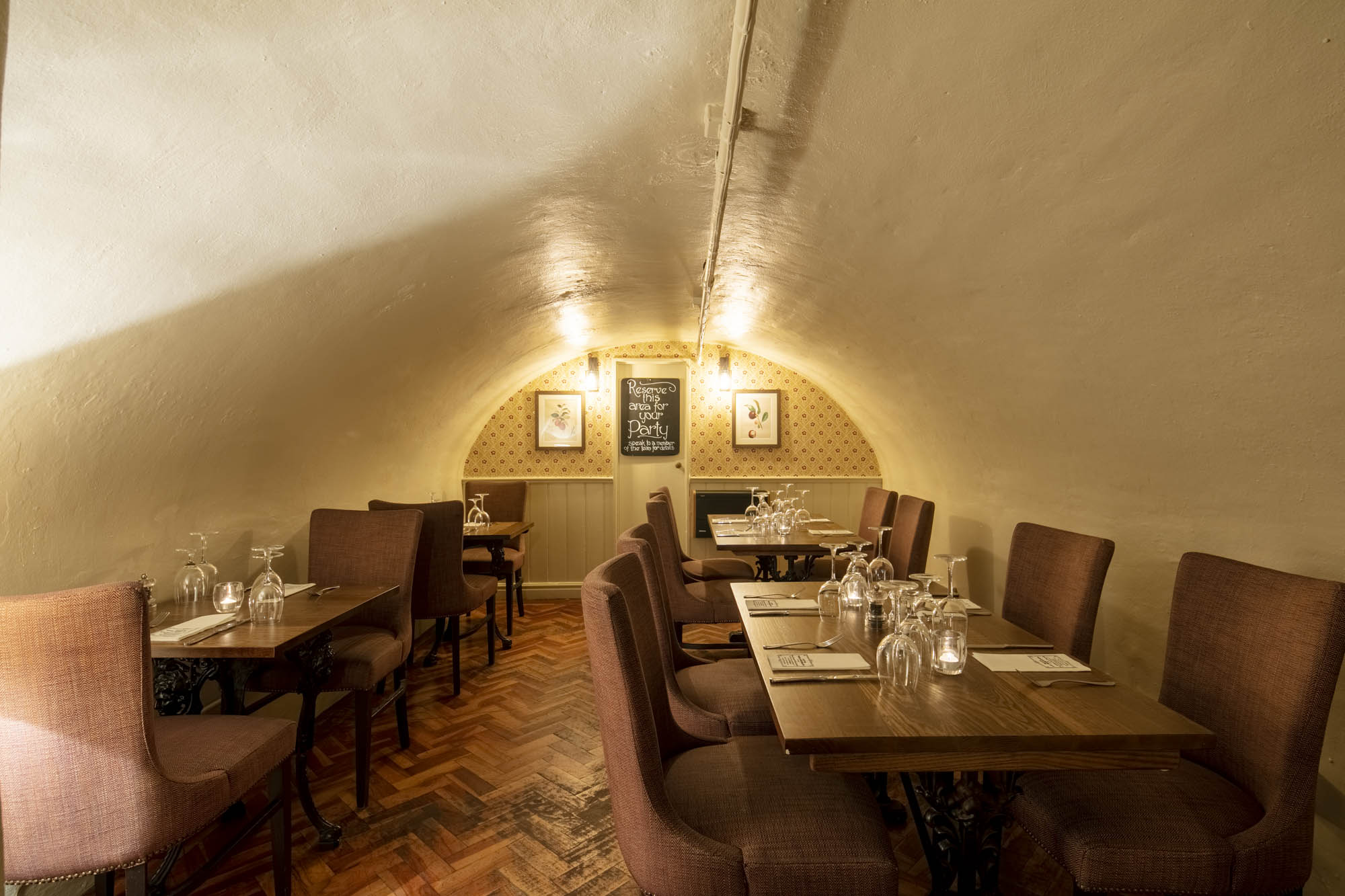 Cozy dining space with arched ceiling at Crusting Pipe, perfect for private events.