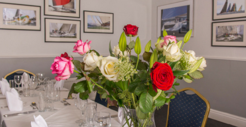Elegant floral centerpiece in Brunswick Suite, Yacht Club for meetings and events.