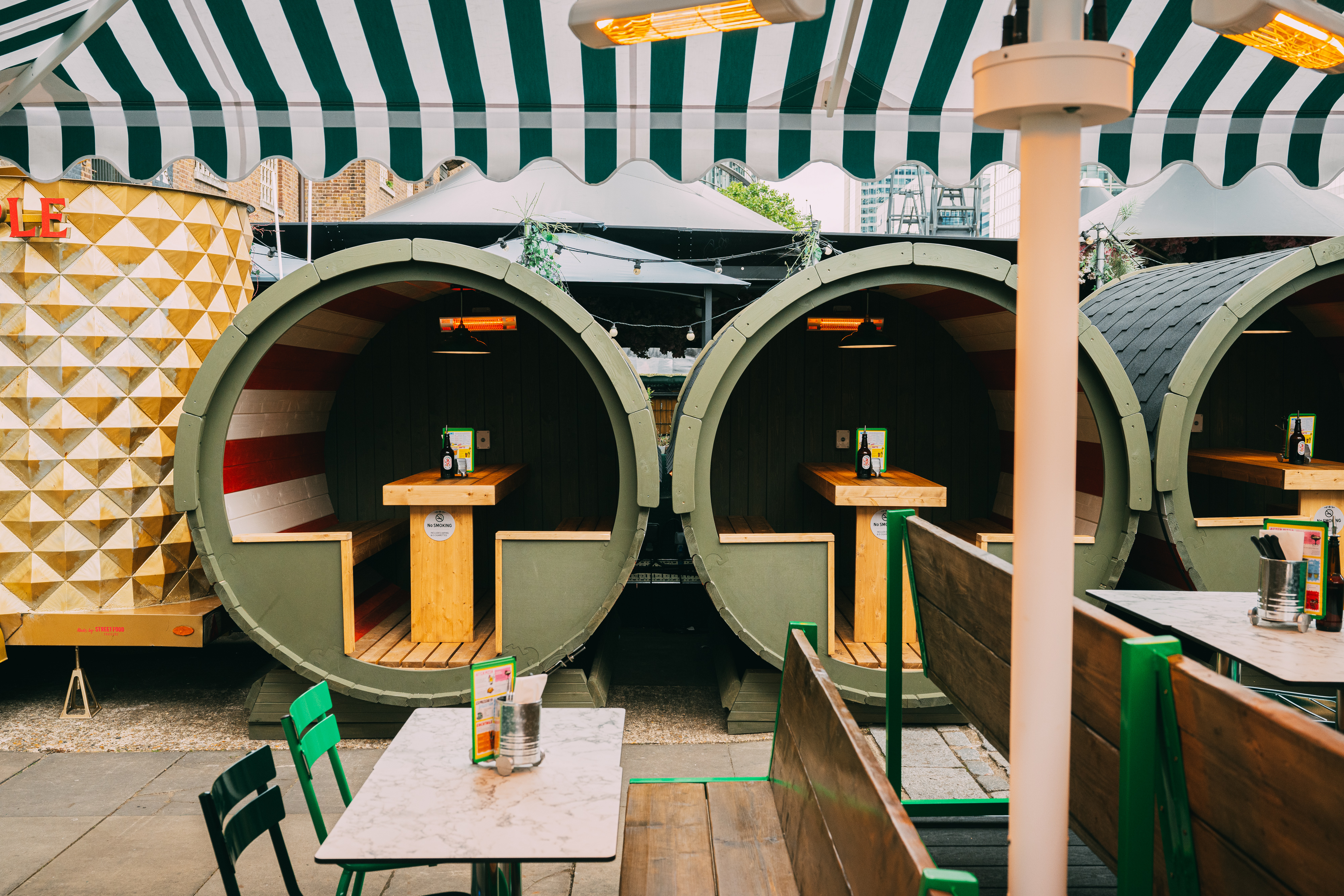 Outdoor event space at The Pizza Playground with colorful booths for casual gatherings.