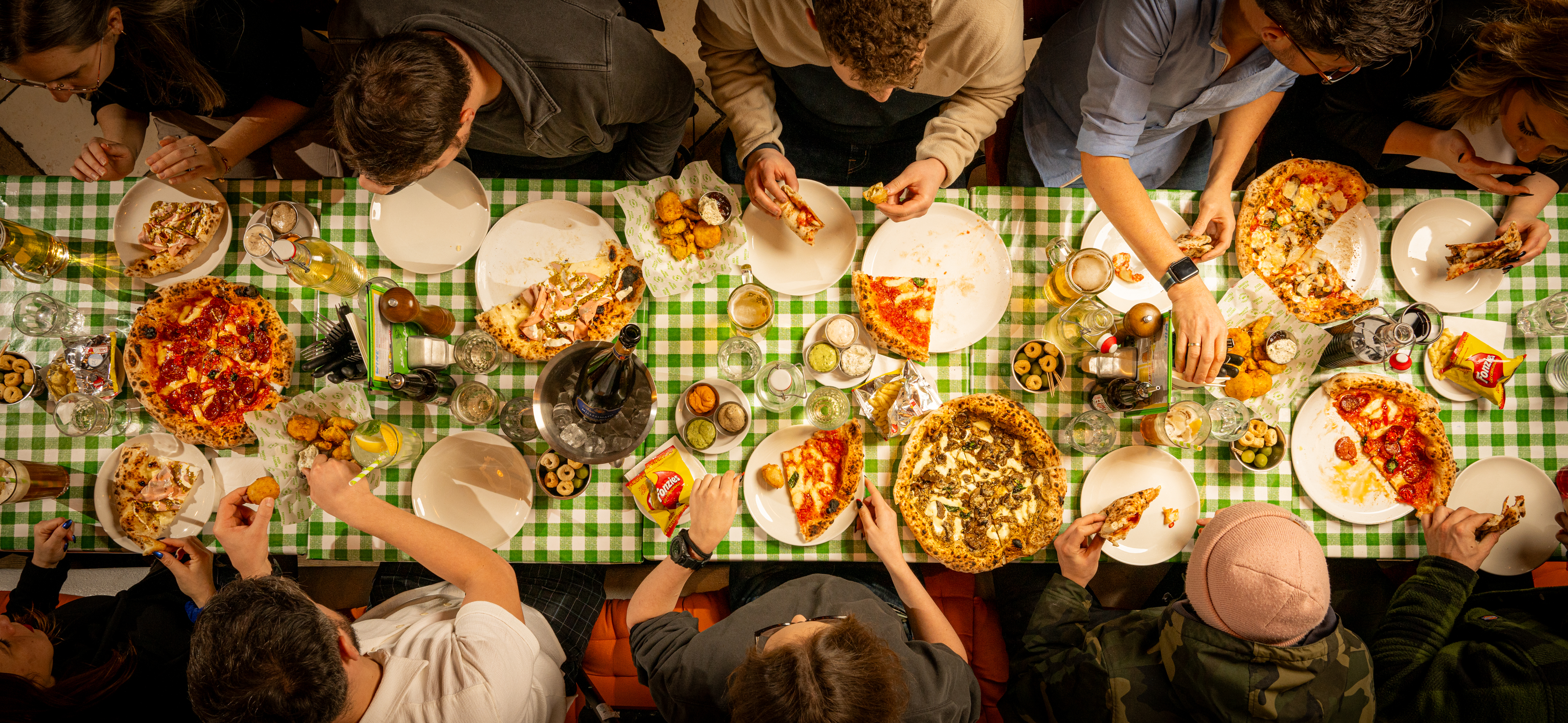 Vibrant communal dining at The Pizza Playground, ideal for team-building events.