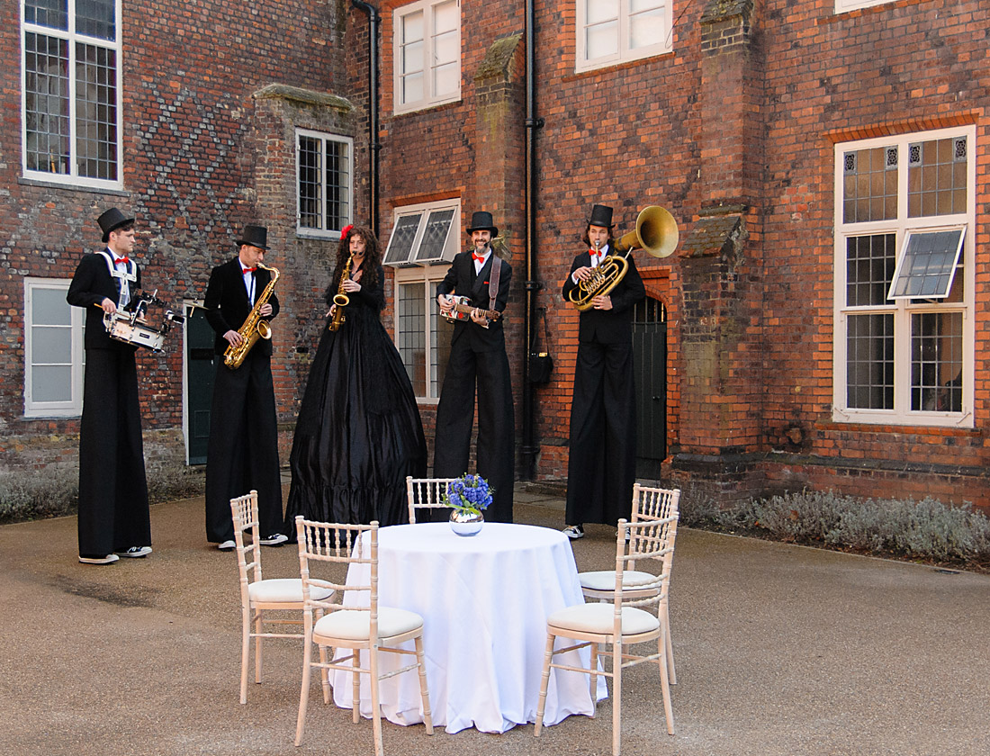 Stilt performers jazz up an elegant outdoor event at Fulham Palace venue hire.