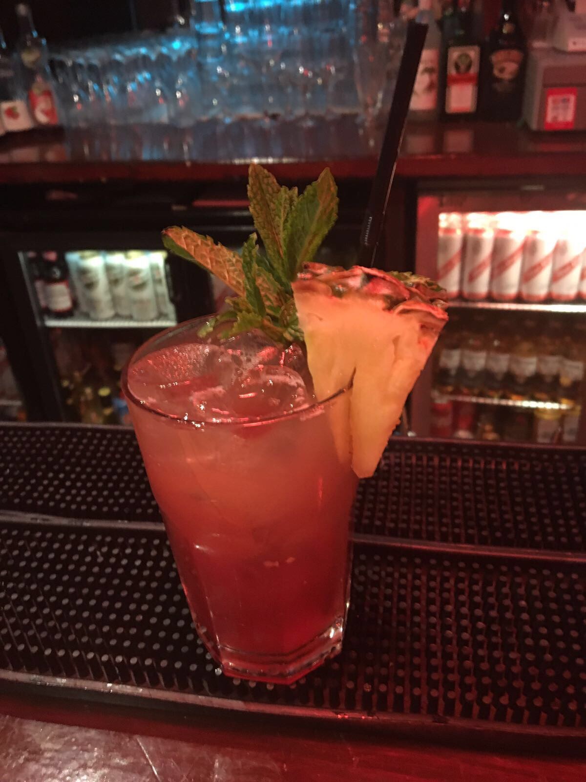 Vibrant cocktail with mint and pineapple at Moustache Bar for events and networking.