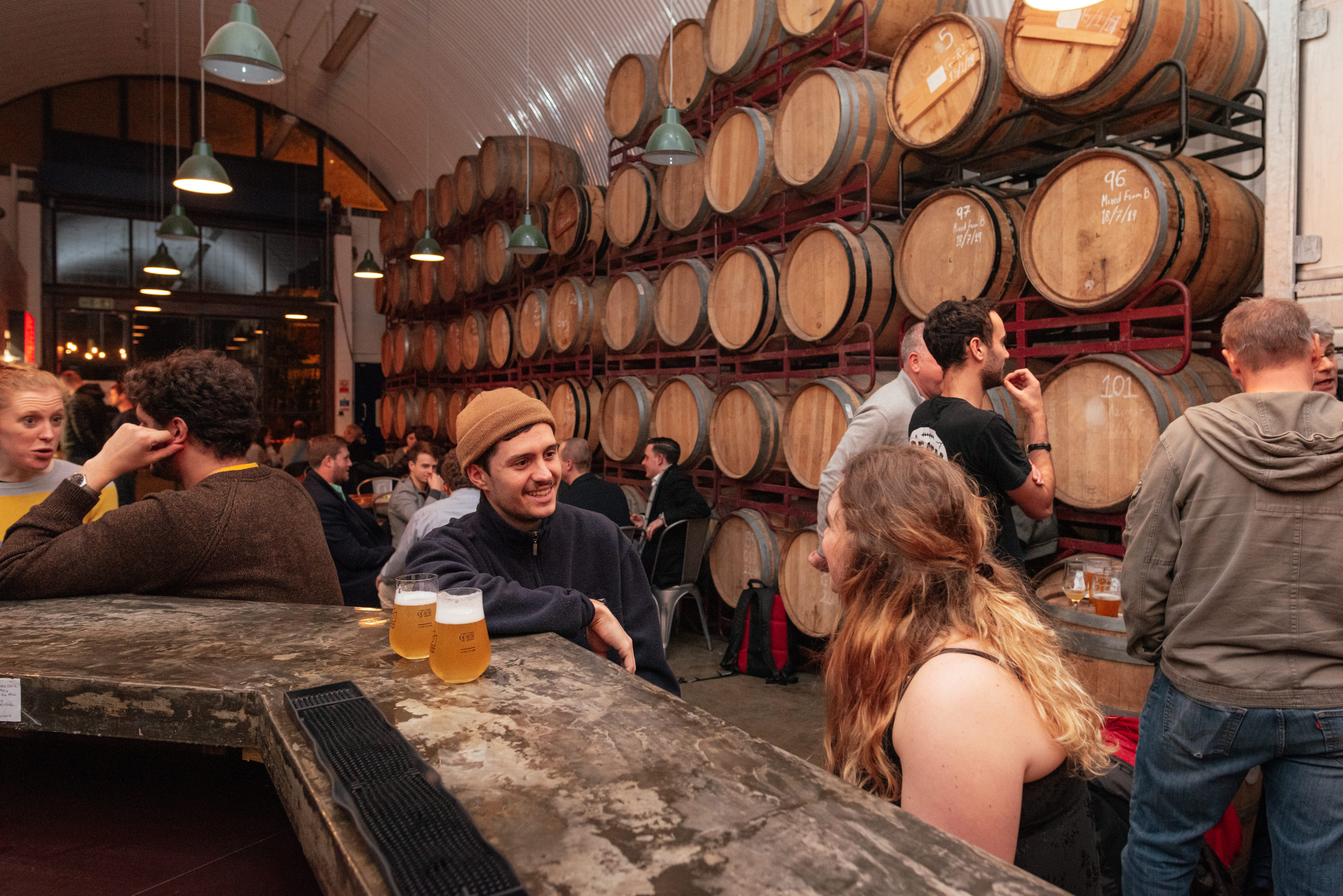 Vibrant rustic venue with wooden barrels, ideal for networking events and gatherings.