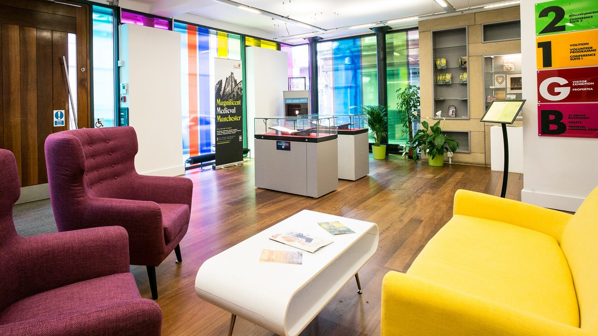 Modern meeting space with colorful glass panels for creative conferences at Manchester Cathedral.