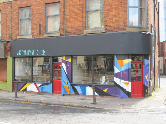 Vibrant venue with colorful mural for creative events and gatherings.