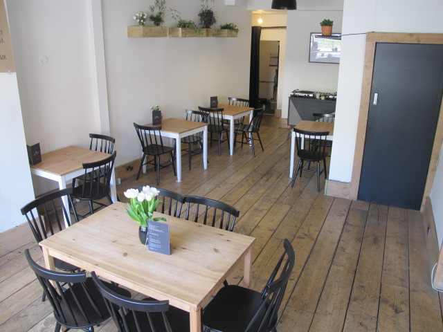 Versatile event space with wooden floors, ideal for meetings and workshops.