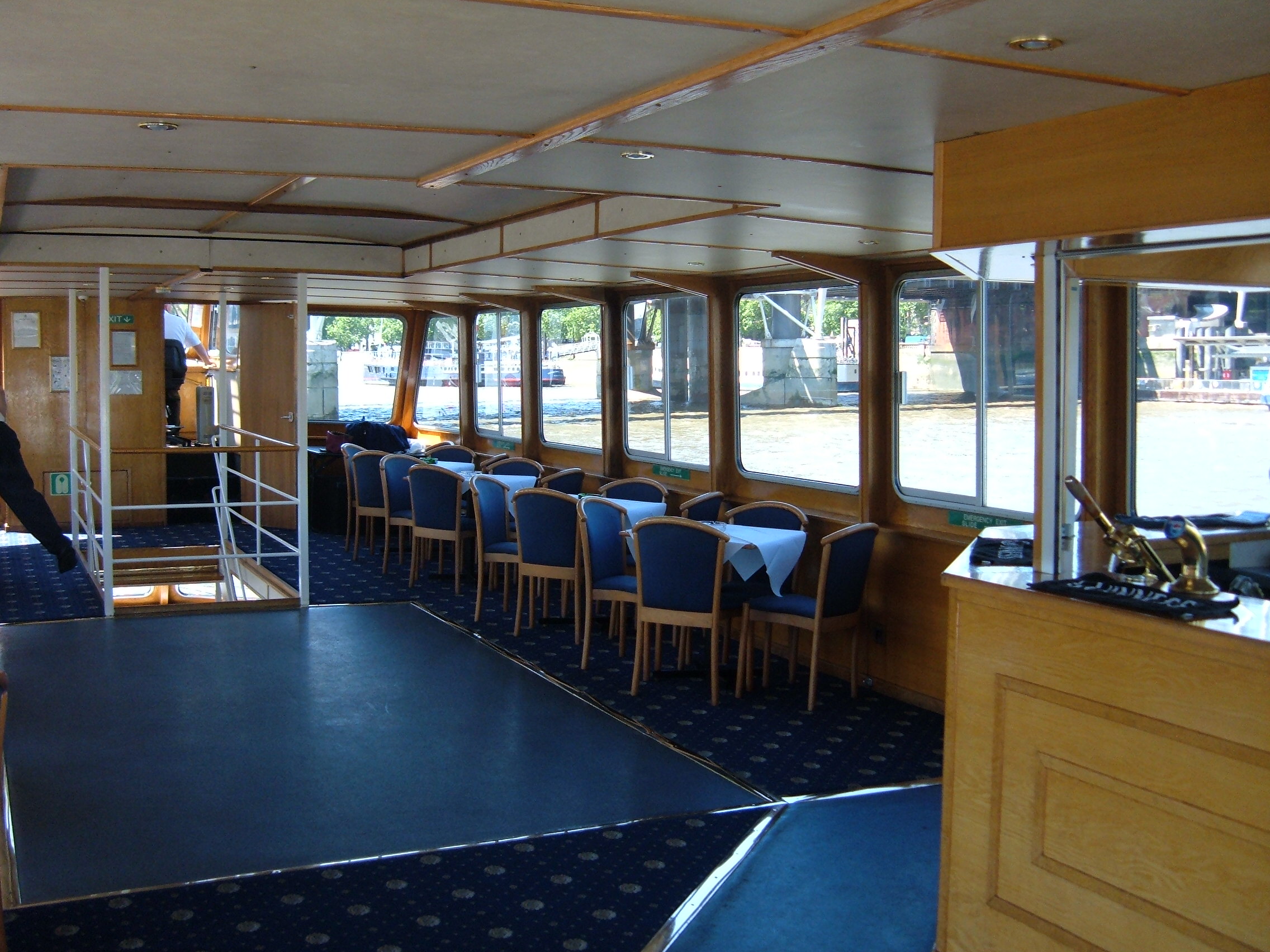Spacious riverboat event space with large windows for networking and private functions.