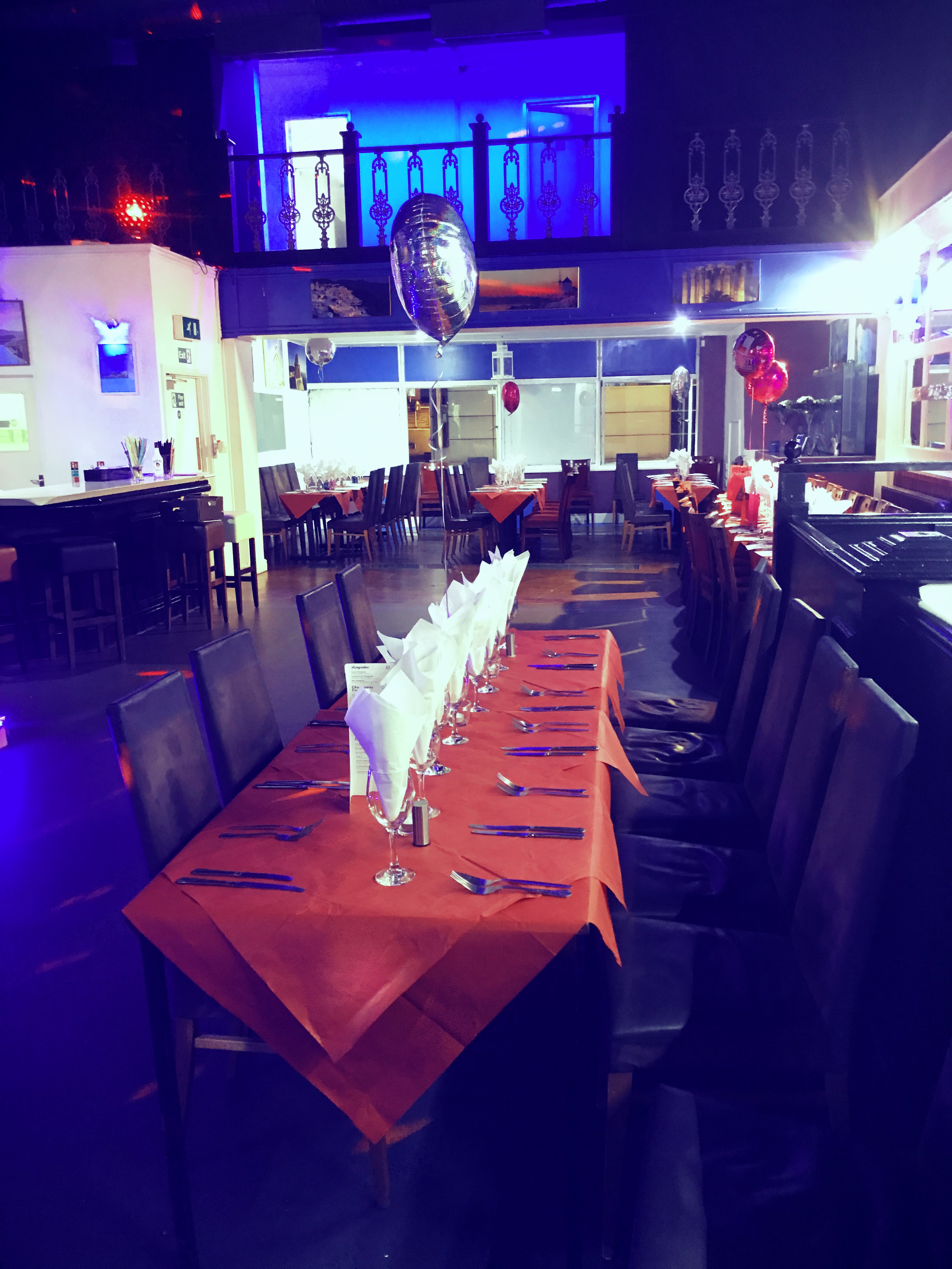 Whole Venue in Santorini Restaurant with orange tablecloths for corporate events and celebrations.