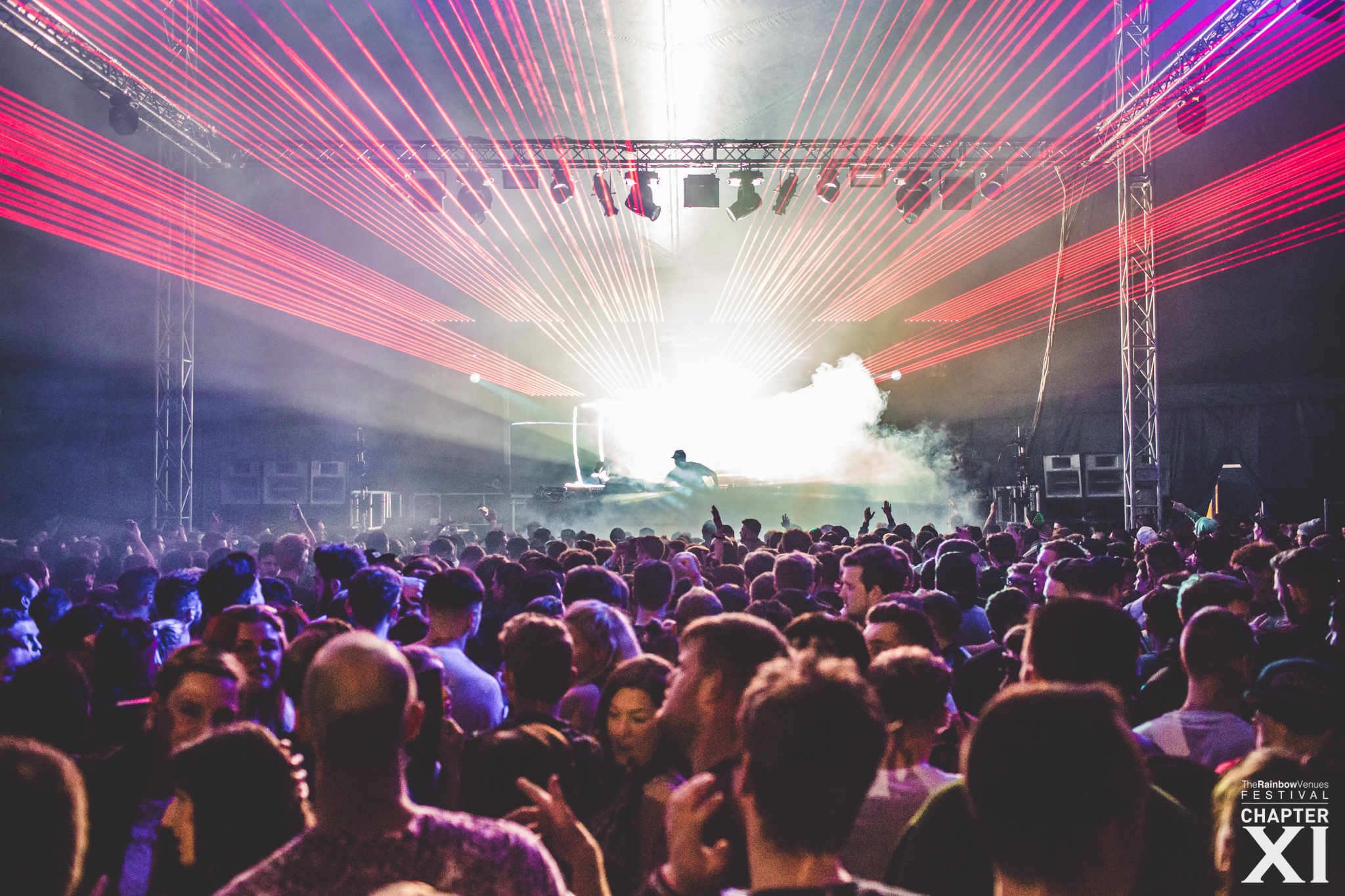 Vibrant crowd at Arena, The Rainbow Venues, showcasing dynamic lighting and lasers.