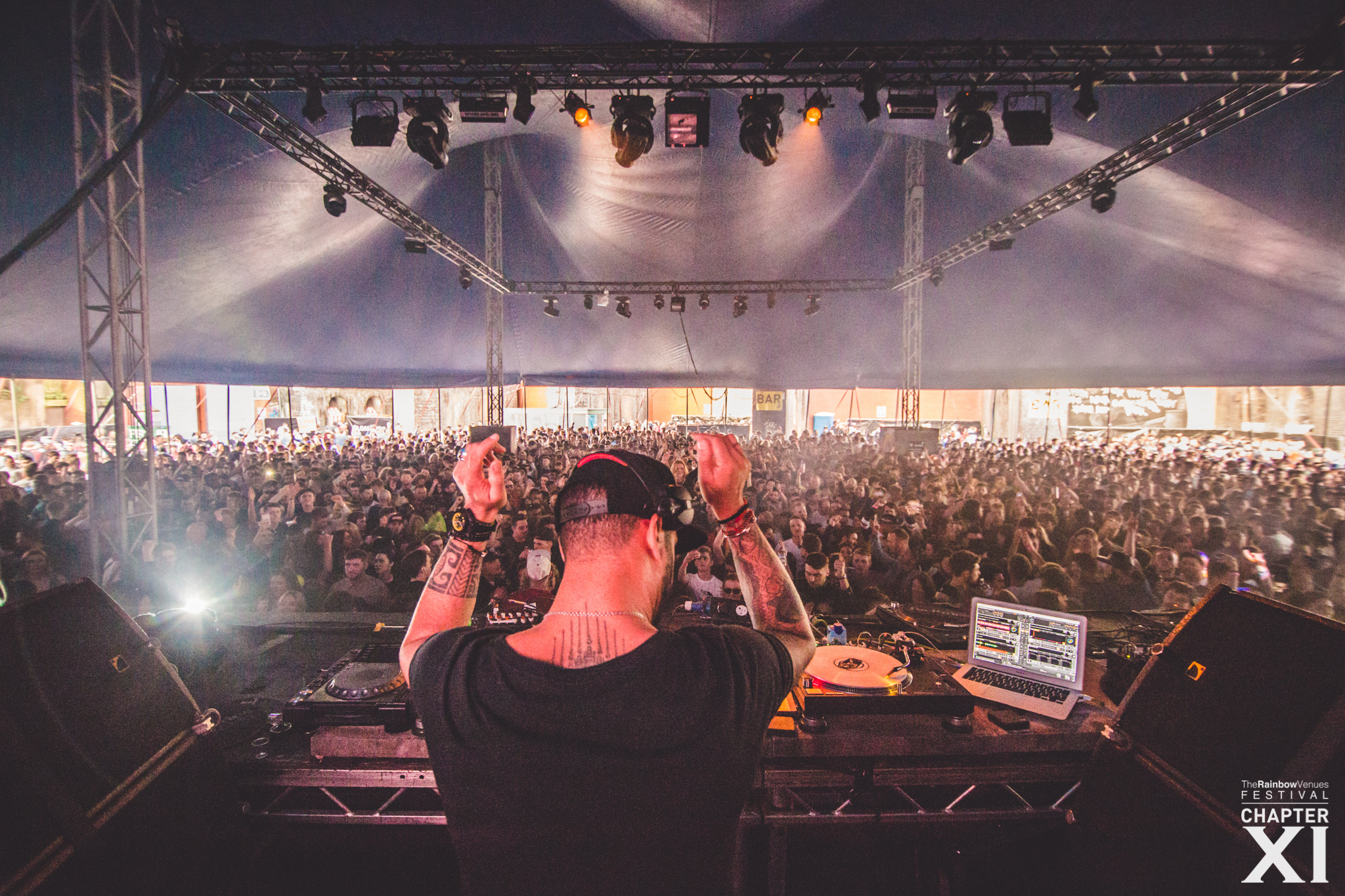 DJ performing at The Rainbow Venues, vibrant live event with engaged audience.