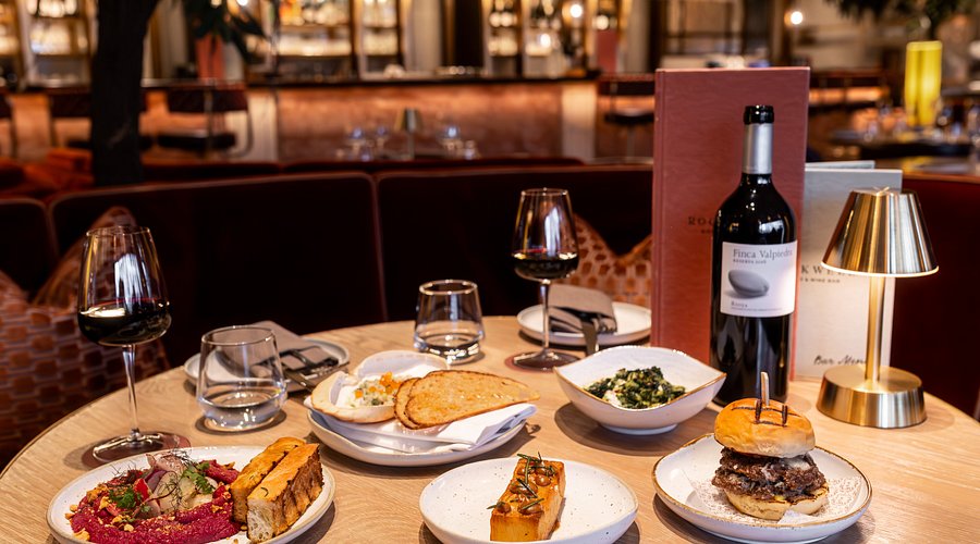 Rockwell Bistro table set with gourmet dishes and wine for corporate dinners or events.