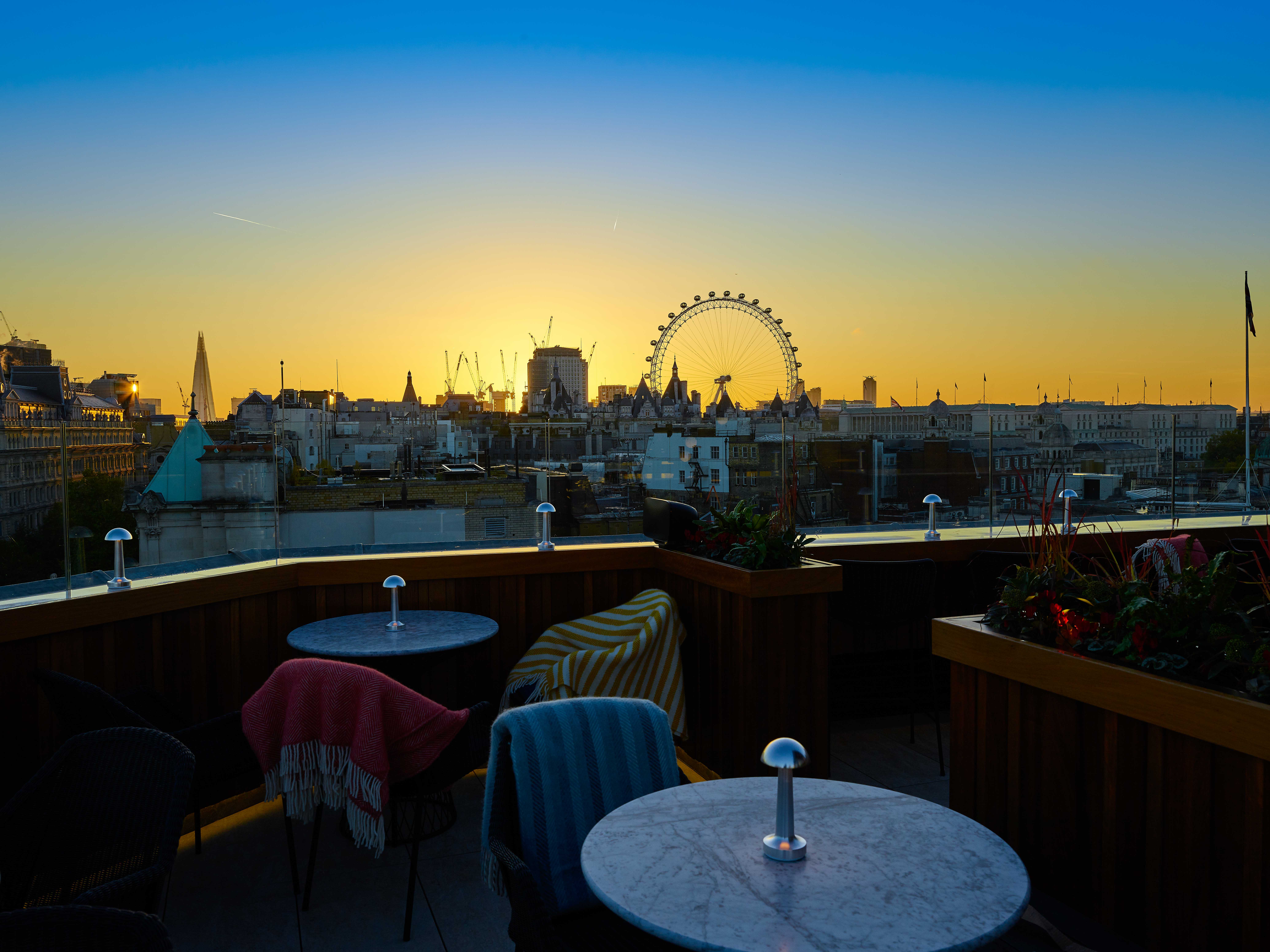 Stunning rooftop view at sunset with London Eye, ideal for upscale events and celebrations.