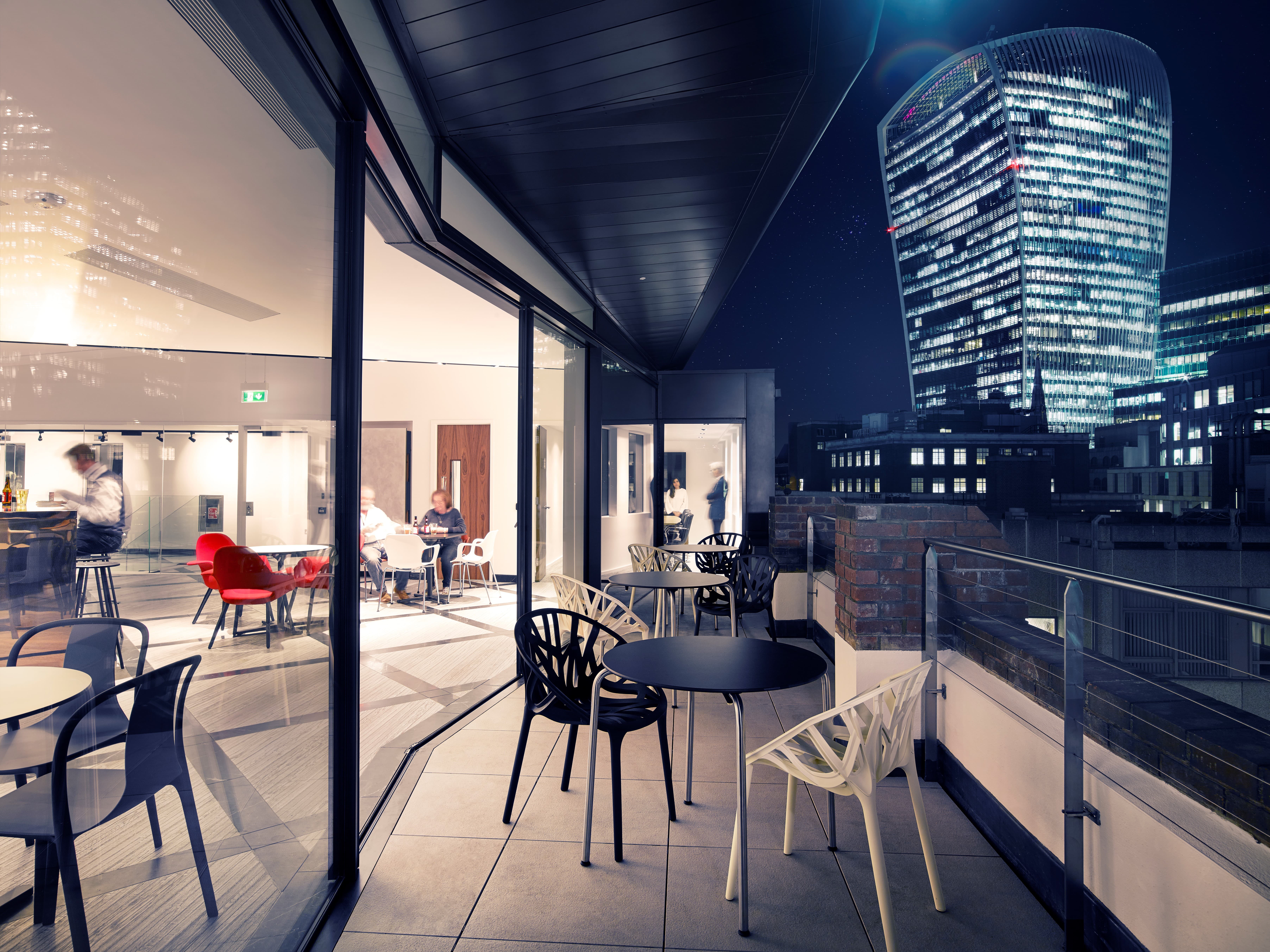 Indoor-outdoor event space at 7 Harp Lane with urban skyline view for networking and receptions.
