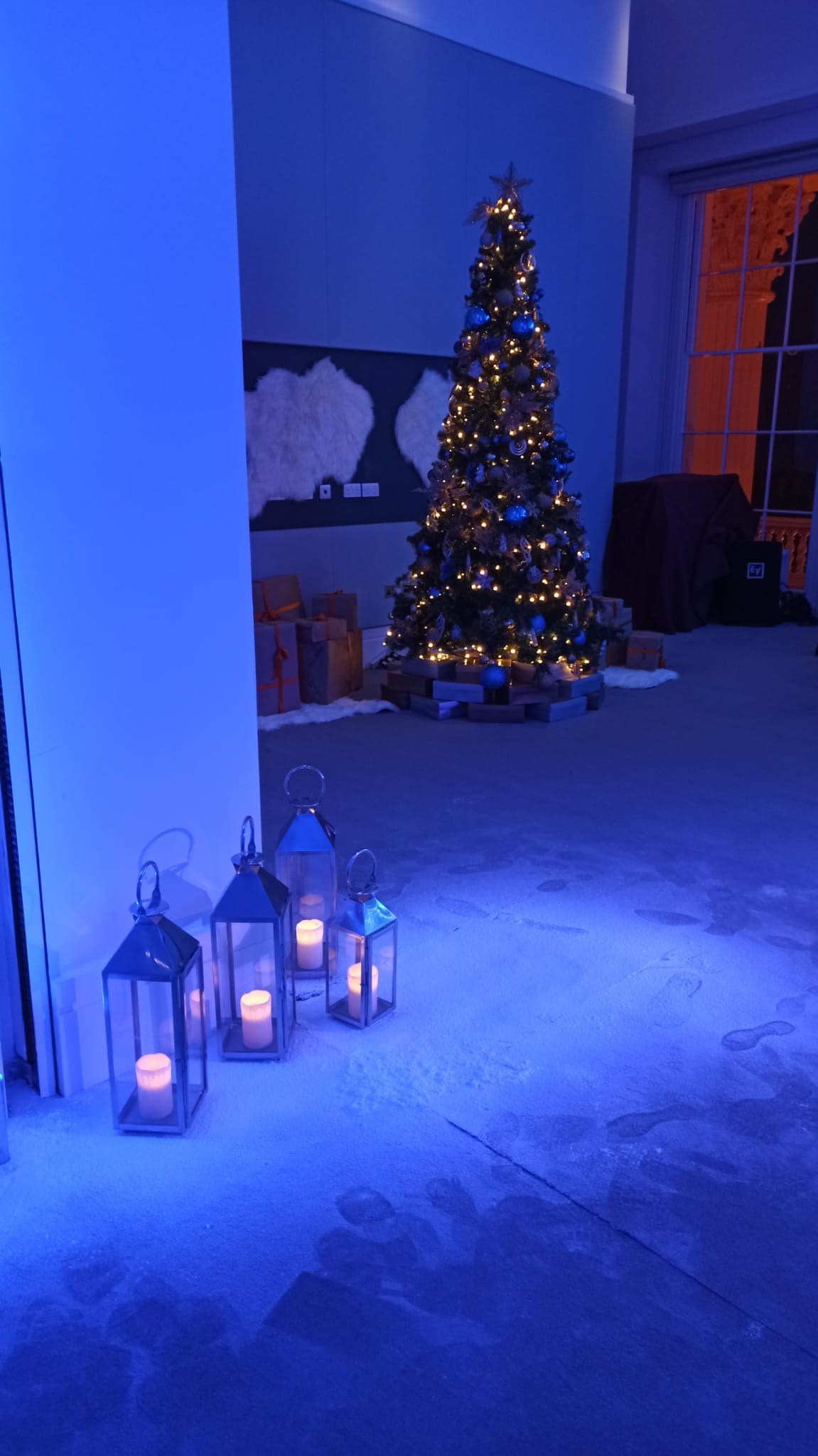 Christmas party at Prince Philip House with a festive tree and elegant lanterns.