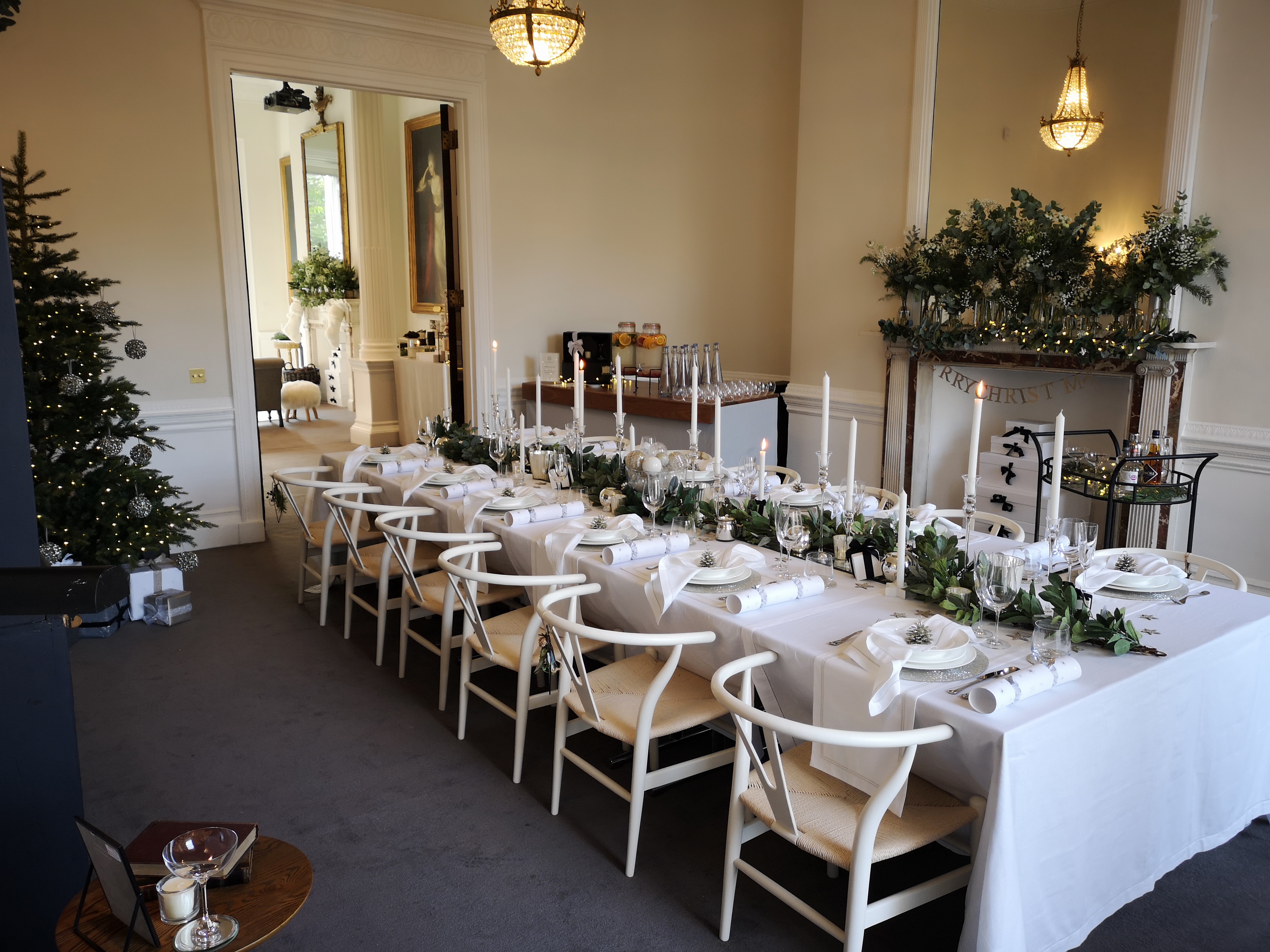 Elegant Christmas dining setup with white linens and greenery at 41 Portland Place.