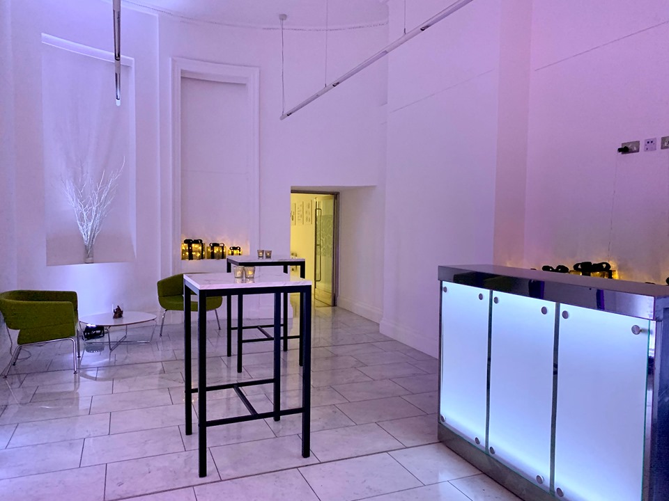 Modern event space at 41 Portland Place, featuring purple lighting for Christmas gatherings.