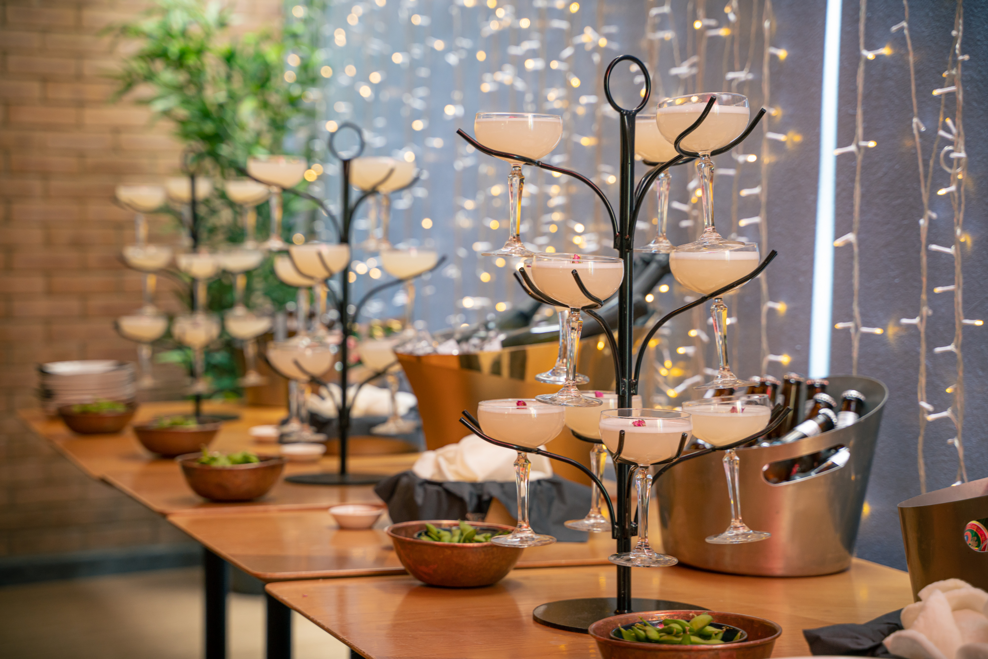 Elegant bar area with cocktail glasses for a sophisticated event at Ping Pong Bow Bell's House.