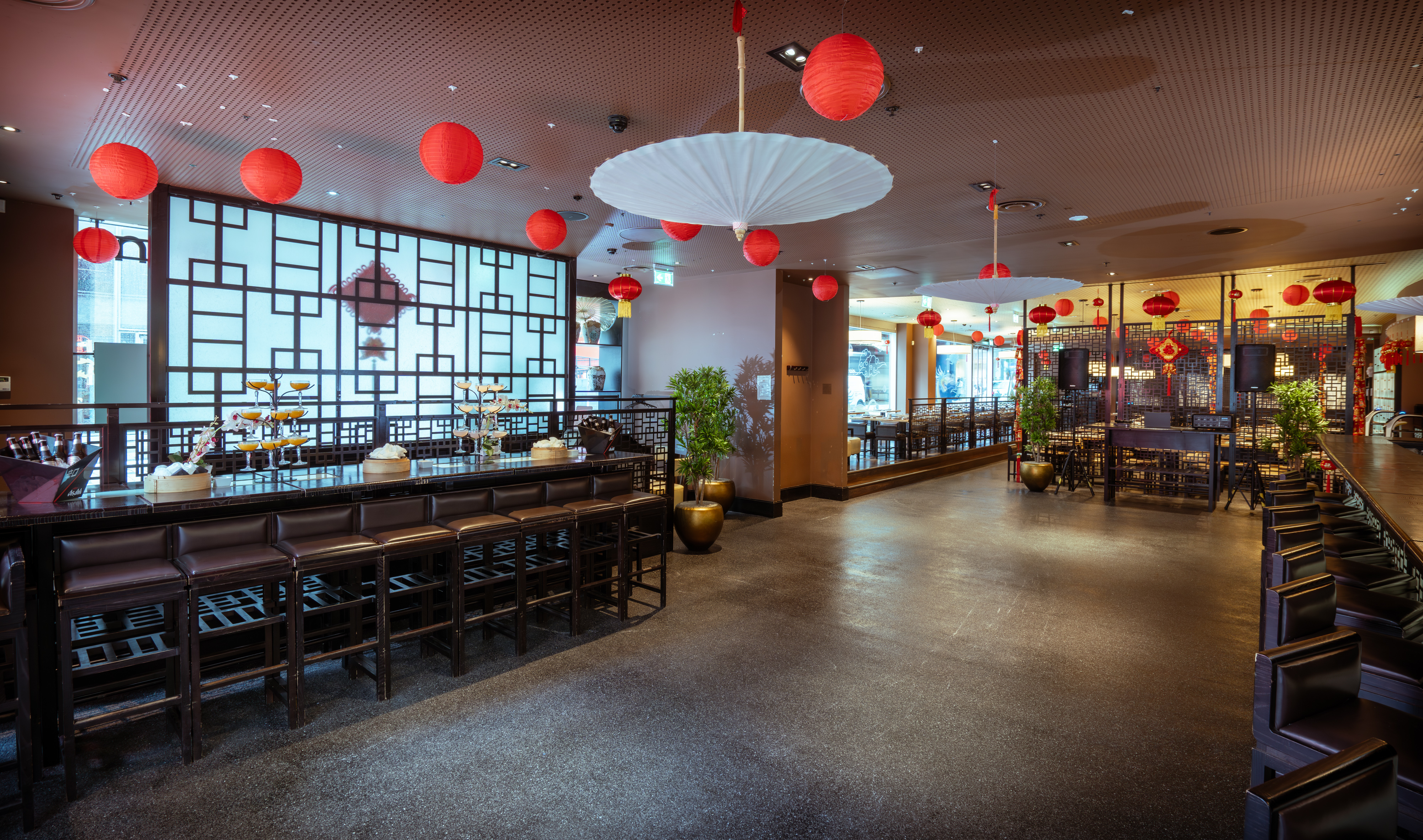 Stylish bar area with red lanterns, perfect for cultural events and intimate dining.