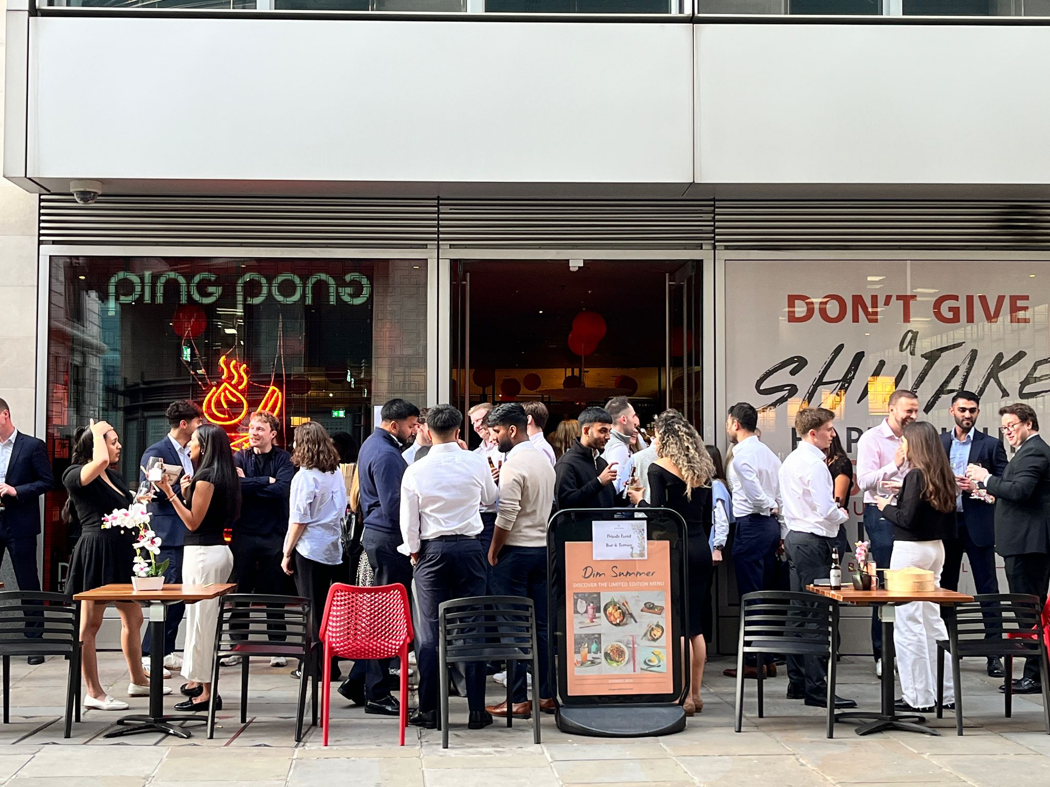 Vibrant networking event at Ping Pong Bow Bell's House with outdoor seating and lively decor.