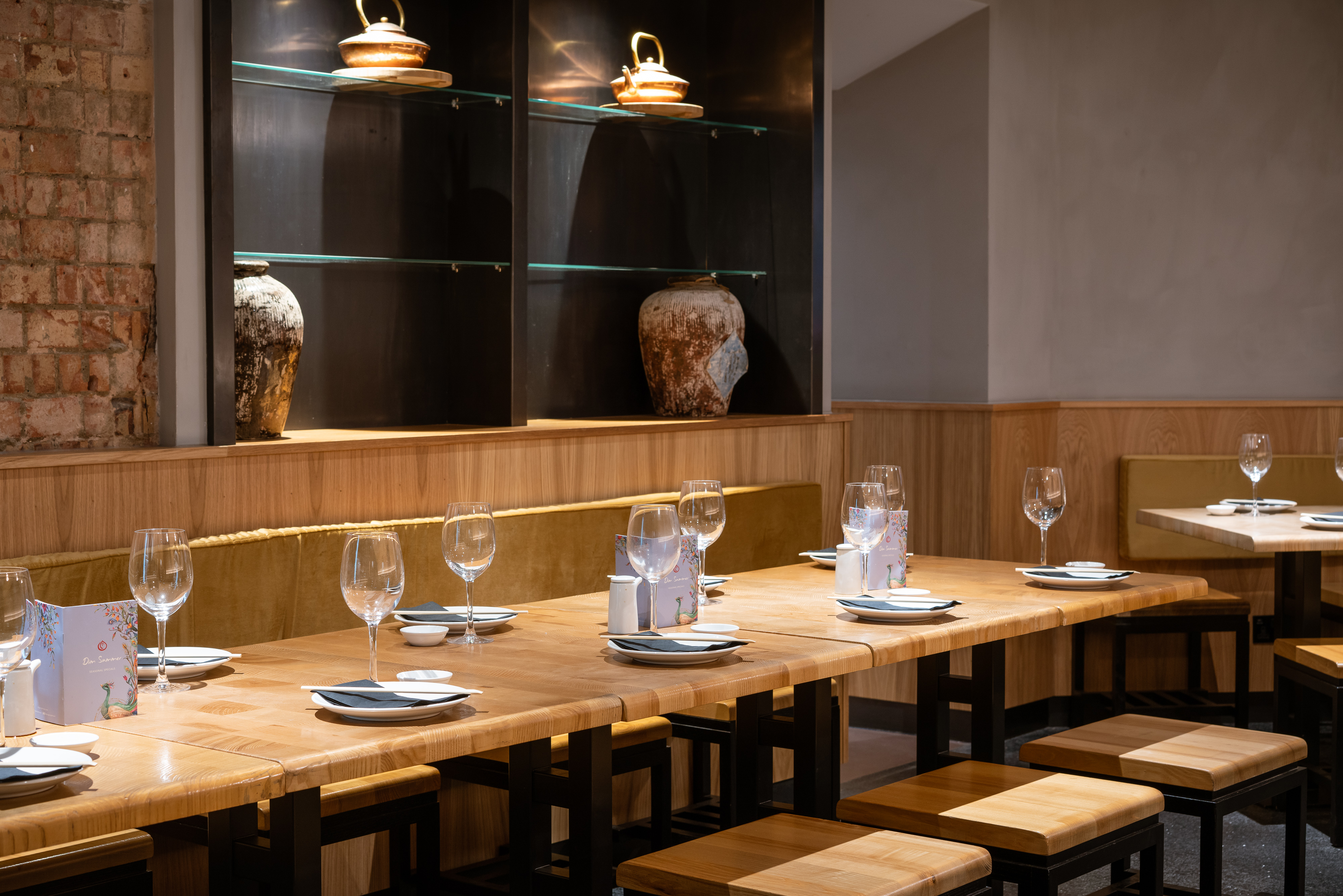 Private dining area with wooden table, ideal for intimate meetings and events.