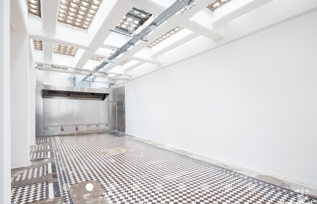 Versatile event space in Abracadabra Hub with polished checkered floor for corporate meetings.