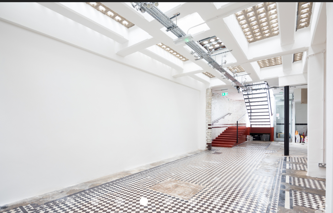 Versatile event space in Abracadabra Hub with high ceilings for meetings and workshops.