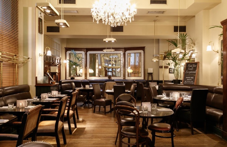 Stylish restaurant space with elegant chandelier for intimate gatherings and corporate events.