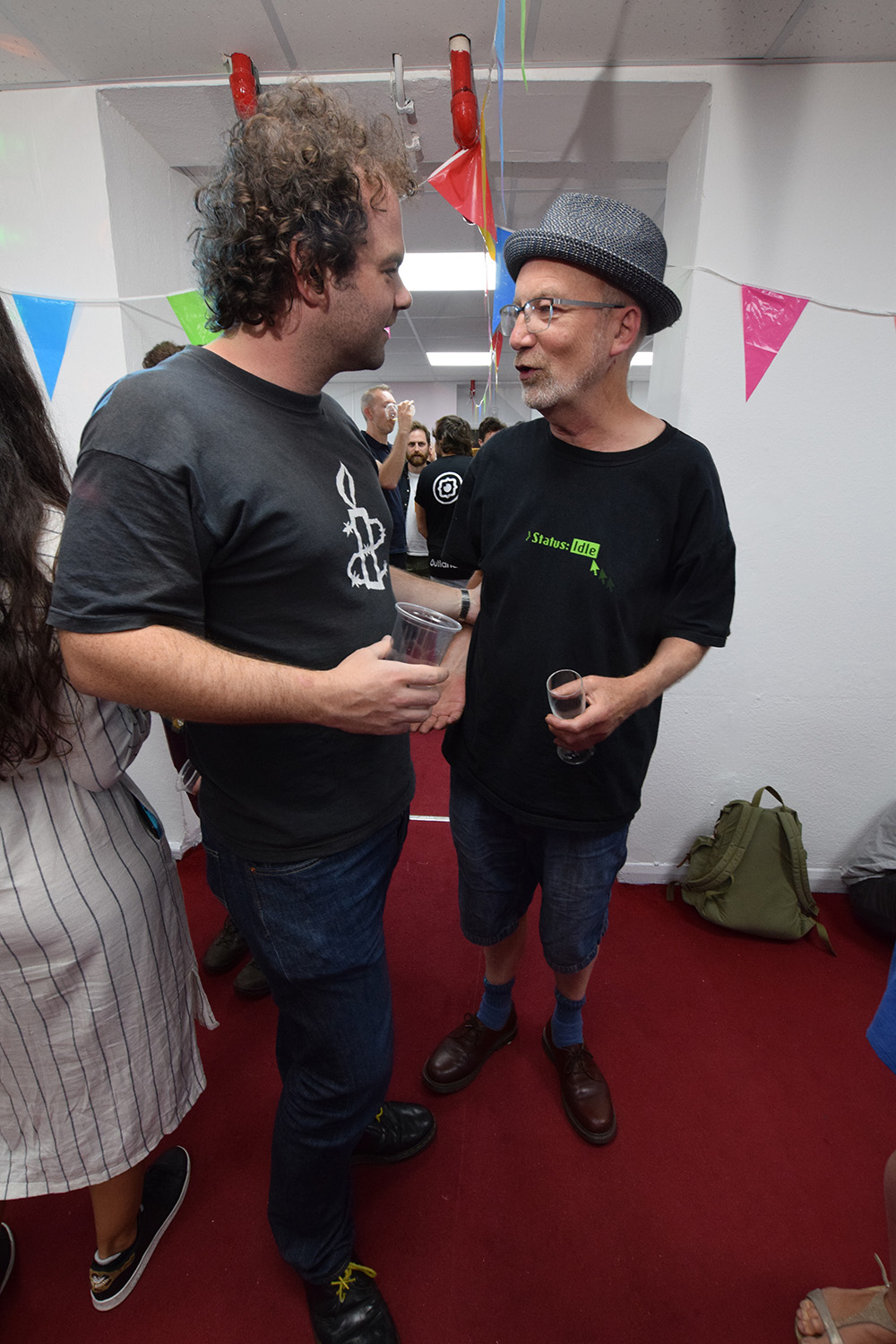 "Attendees networking at Space4 event with festive decorations, fostering collaboration."