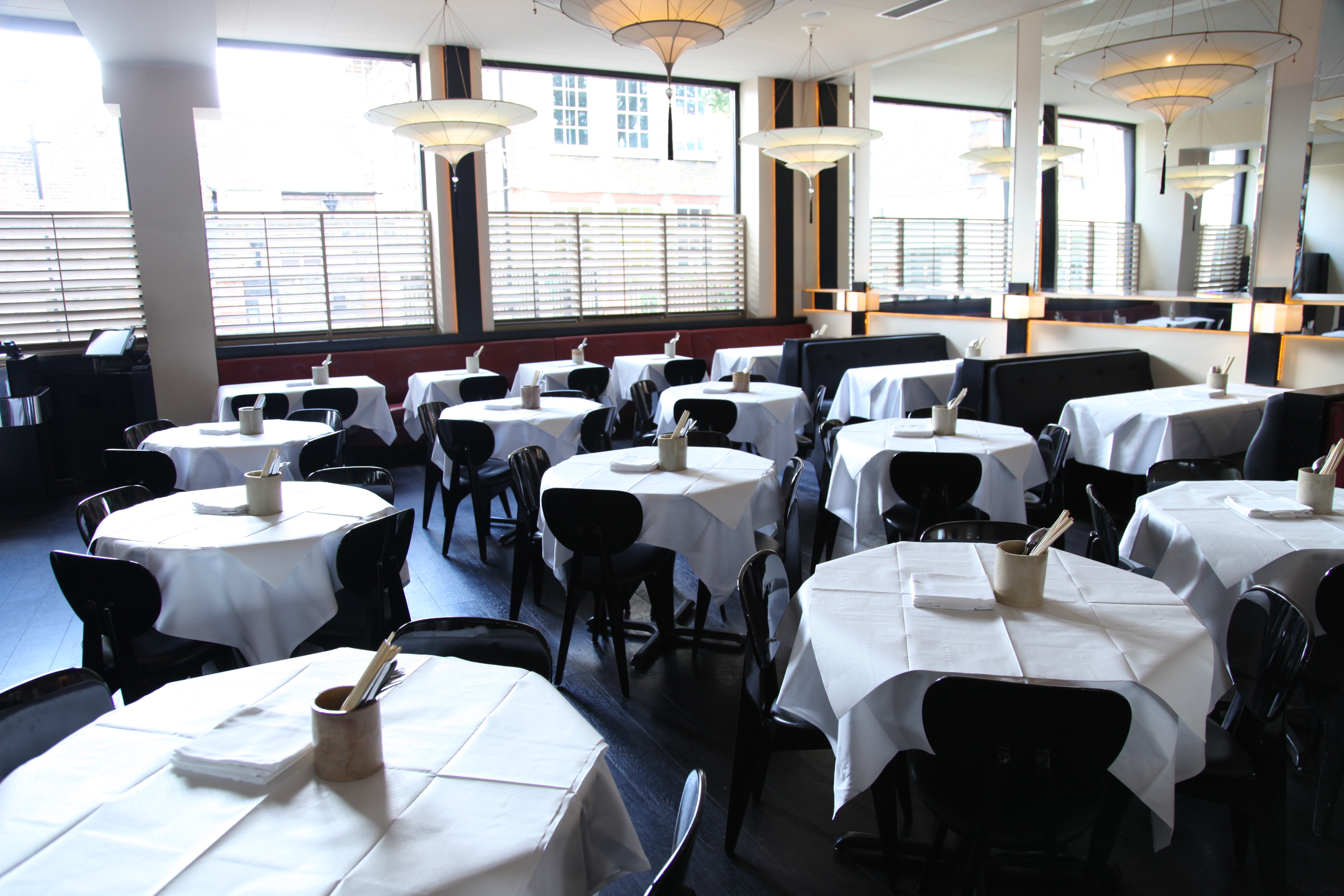 Private dining room with round tables at Alberts Club, ideal for events and gatherings.