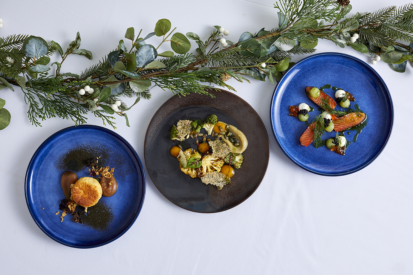 Elegant Christmas dining with gourmet dishes on blue plates at 41 Portland Place.