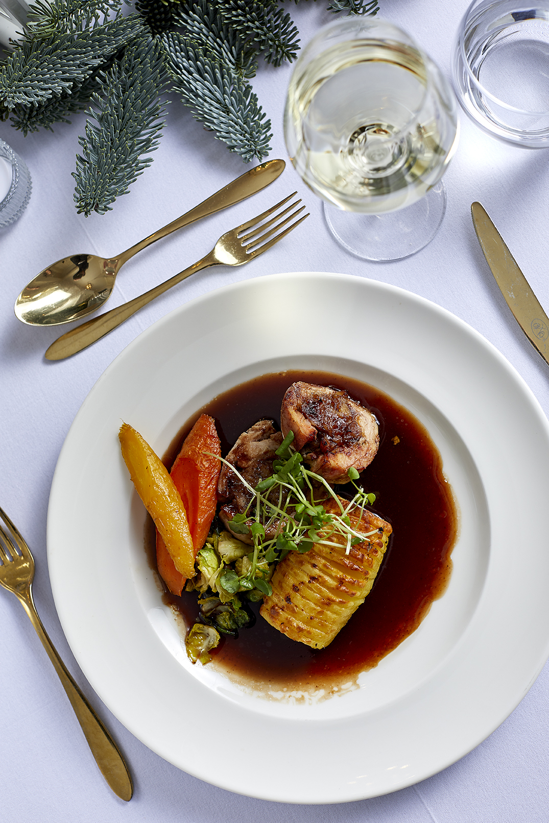 Elegant plated dish with roasted vegetables for upscale Christmas events.