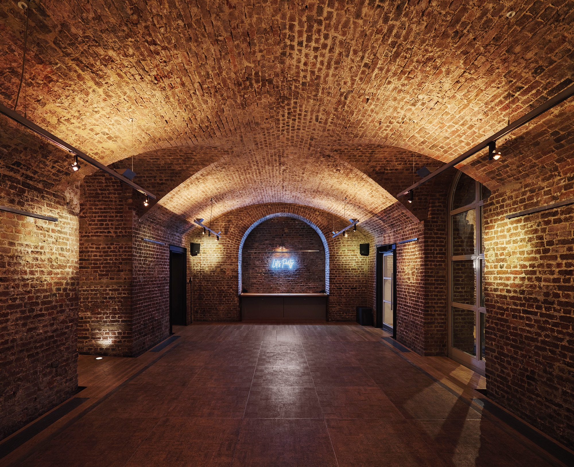 Christmas party venue with exposed brick walls and arched ceiling at RSA House.