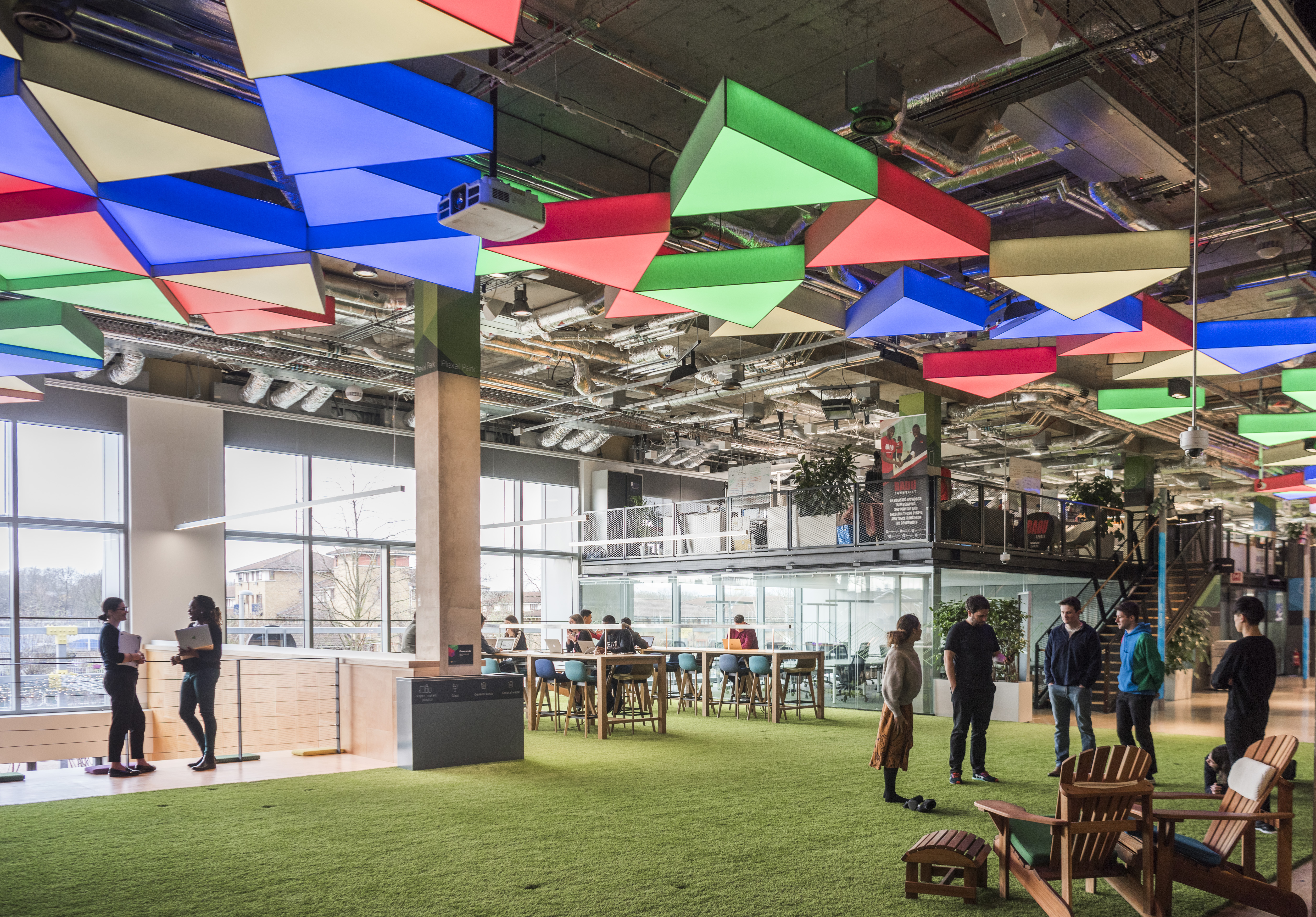 Vibrant CENTRE STAGE event space with colorful ceiling, ideal for meetings and workshops.