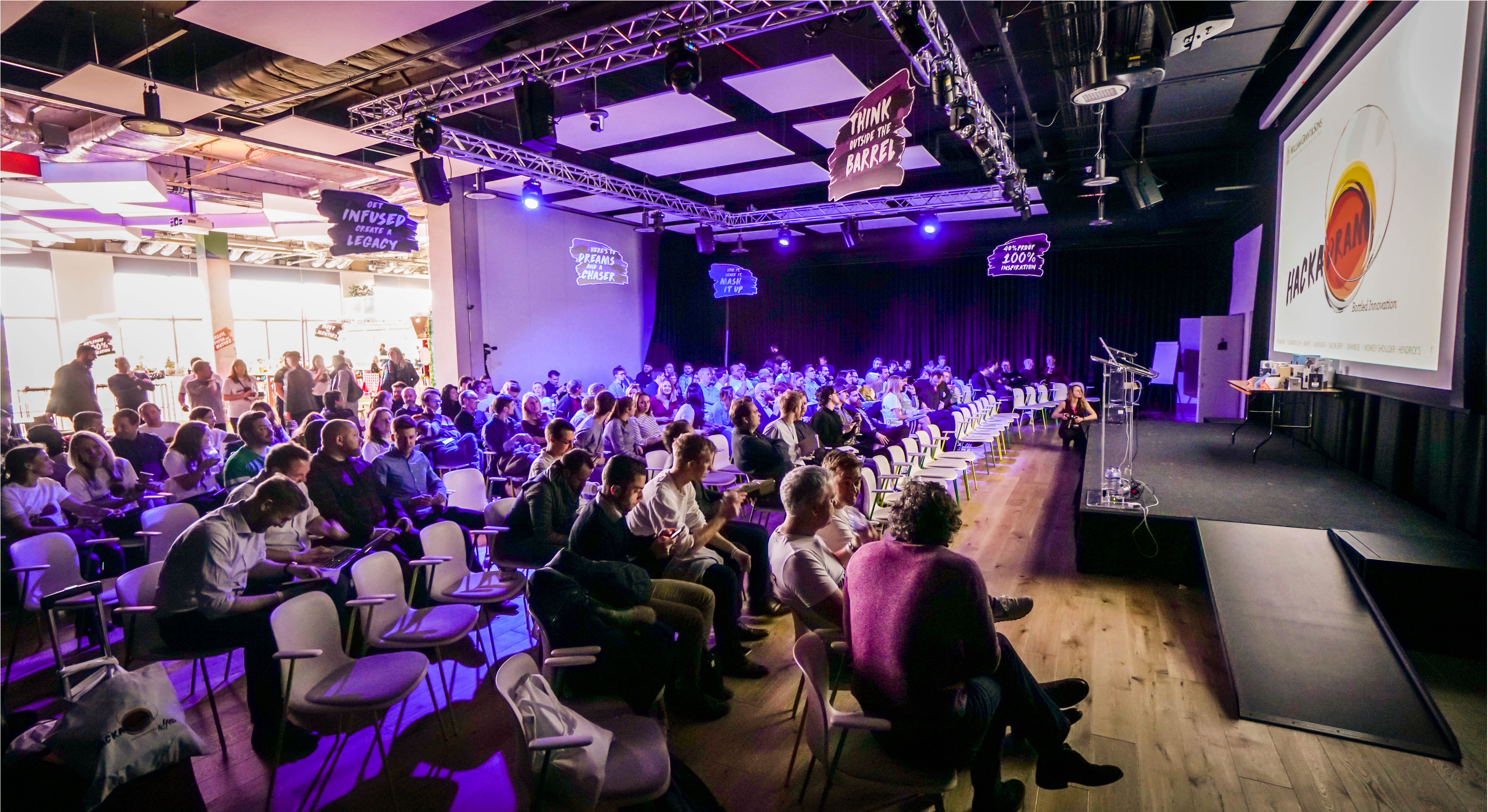 Conference auditorium with dynamic lighting, ideal for networking and knowledge sharing.