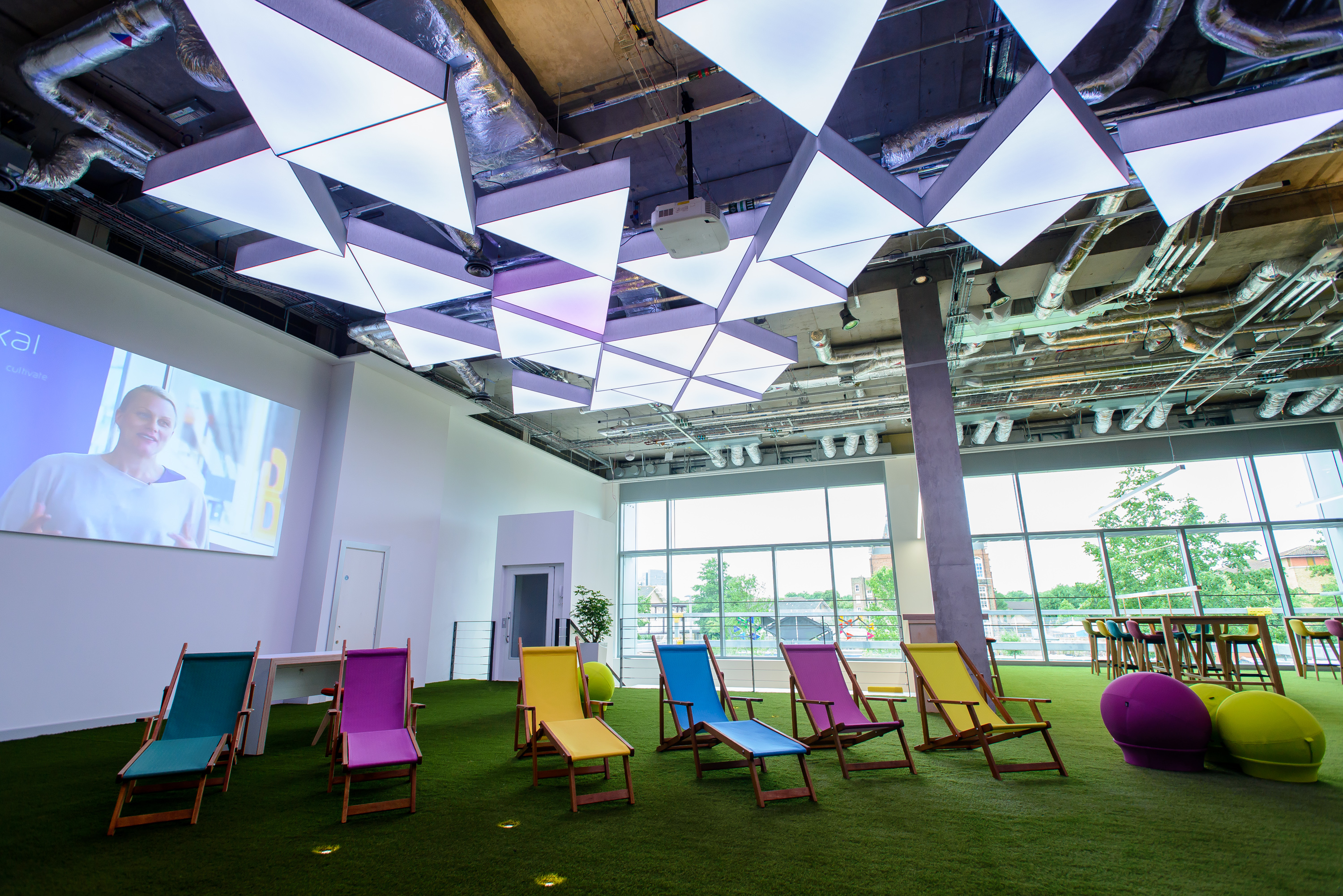 Modern event space with vibrant lounge chairs, ideal for workshops and team-building.