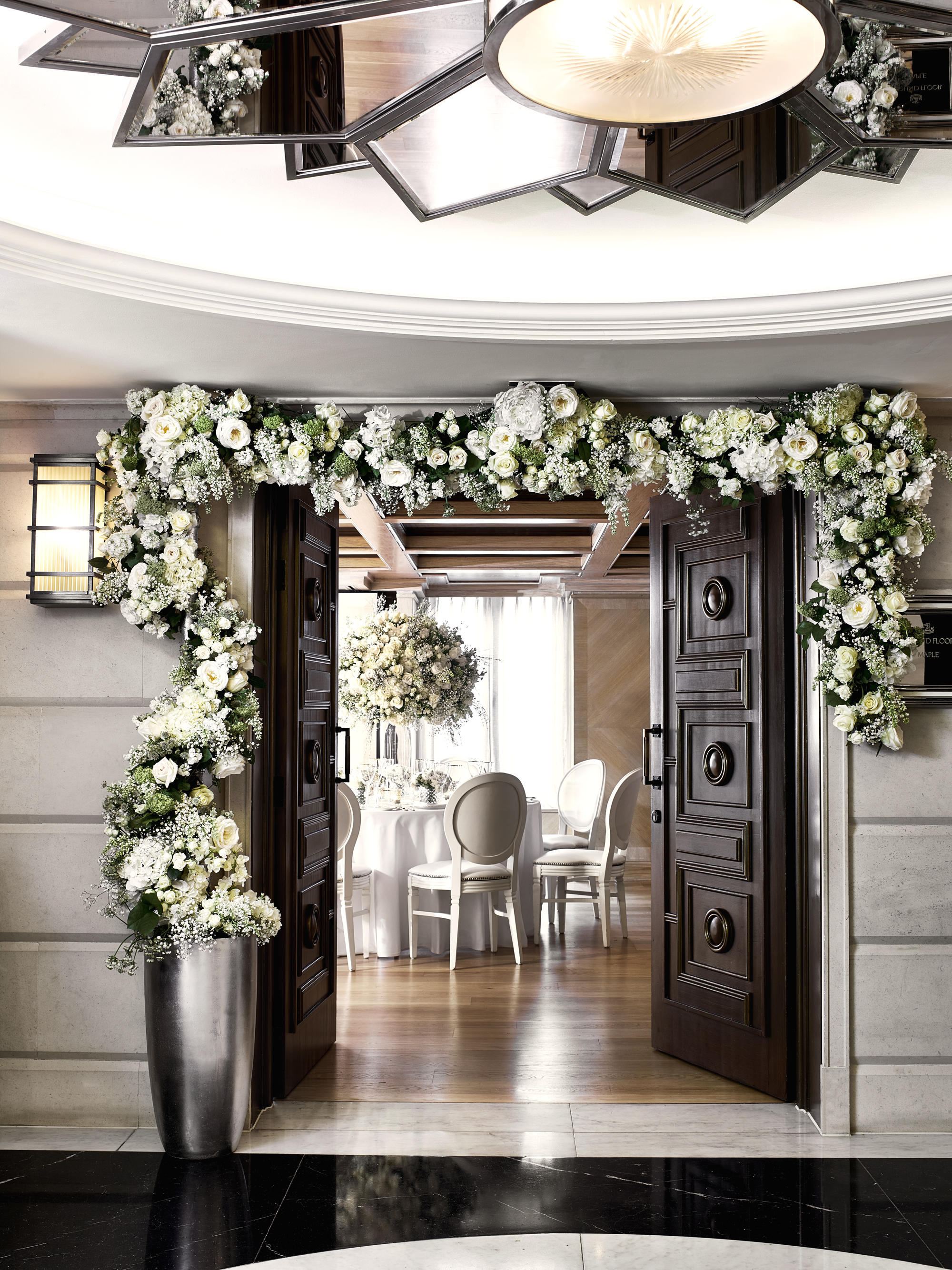 Elegant floral arch at The Connaught's Maple Room, perfect for weddings and upscale events.