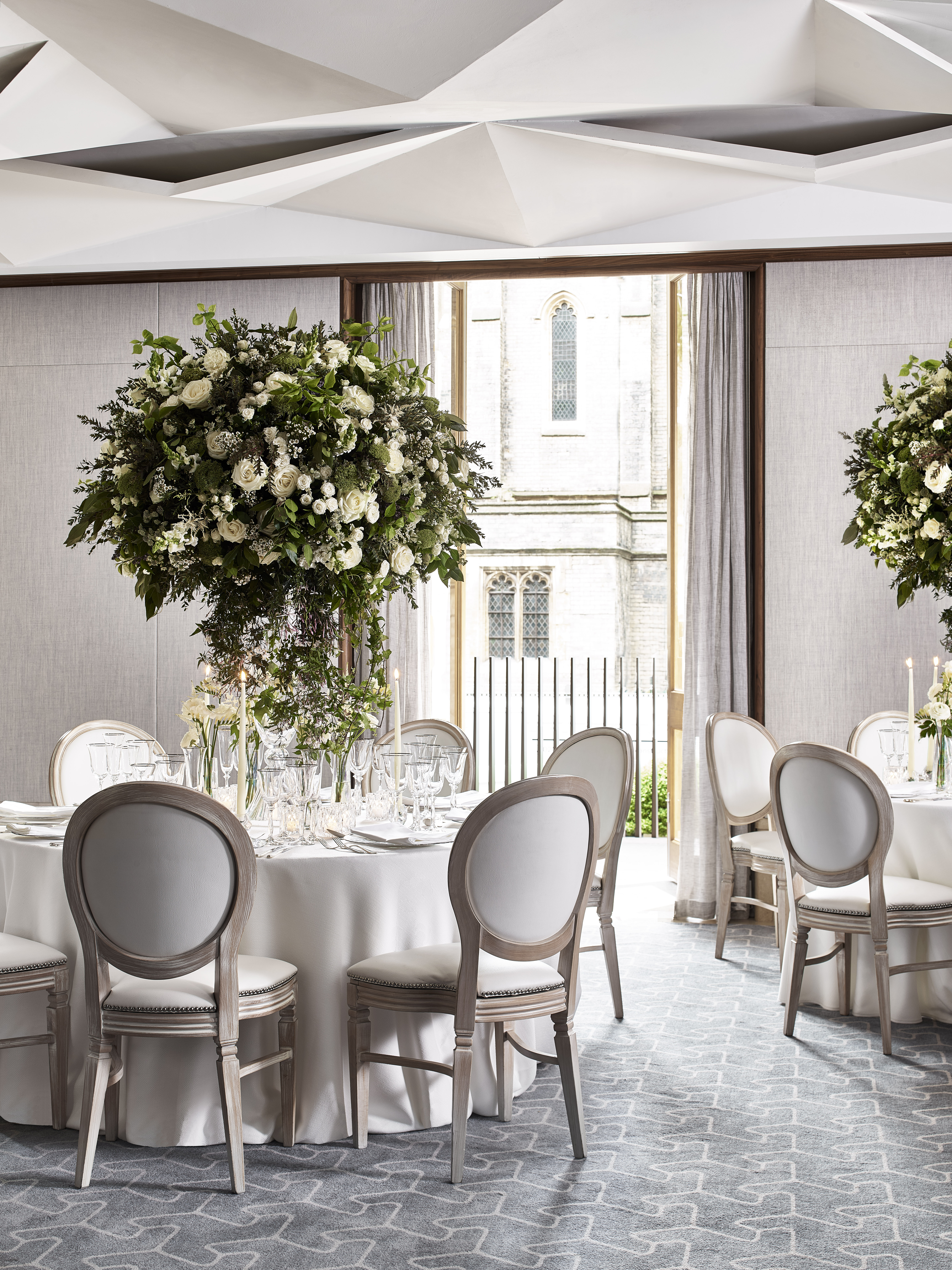 Elegant dining space in Belgravia, featuring tall floral arrangements for weddings and events.