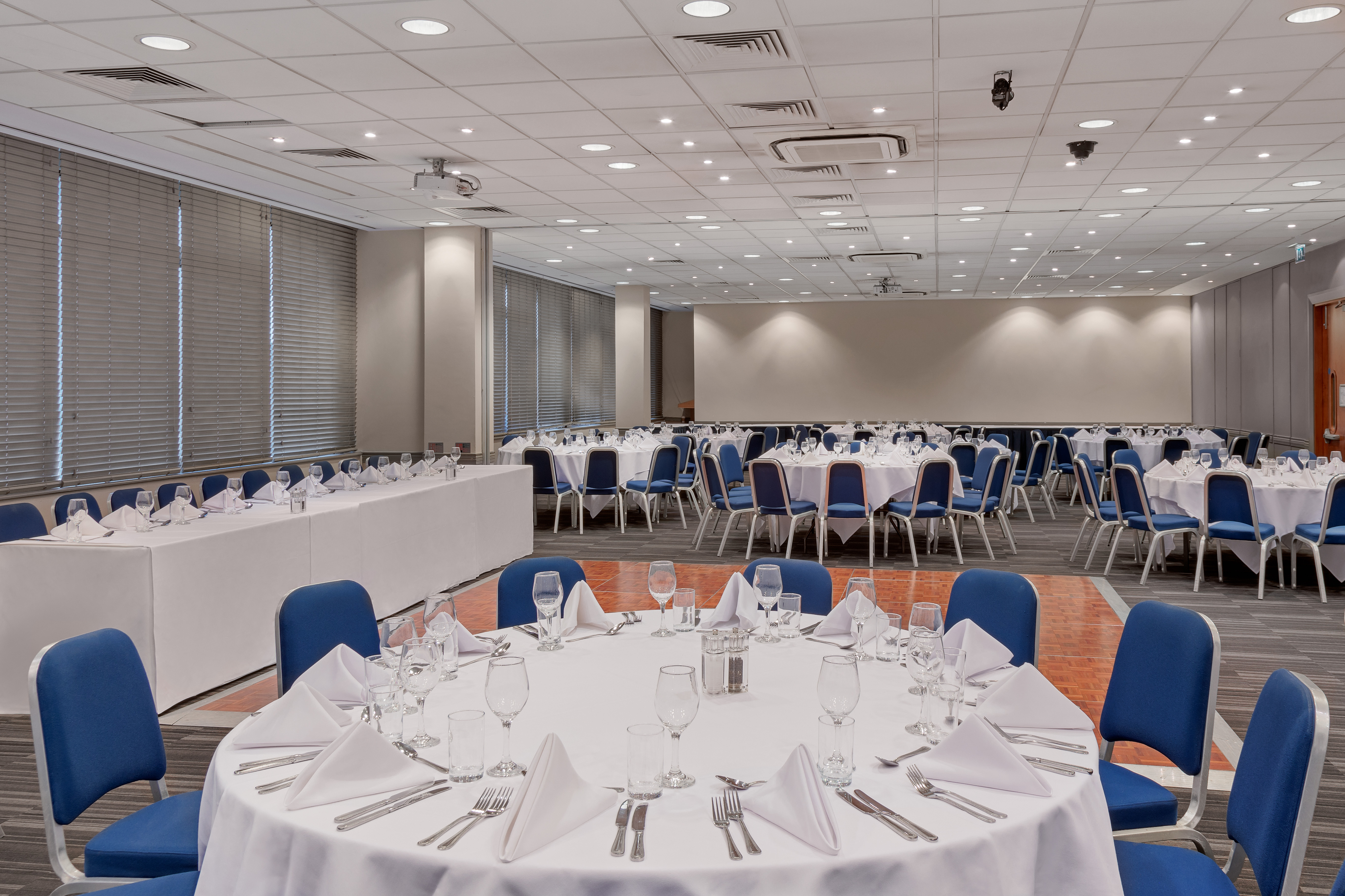 Event space at Holiday Inn London Kensington with round tables for conferences.