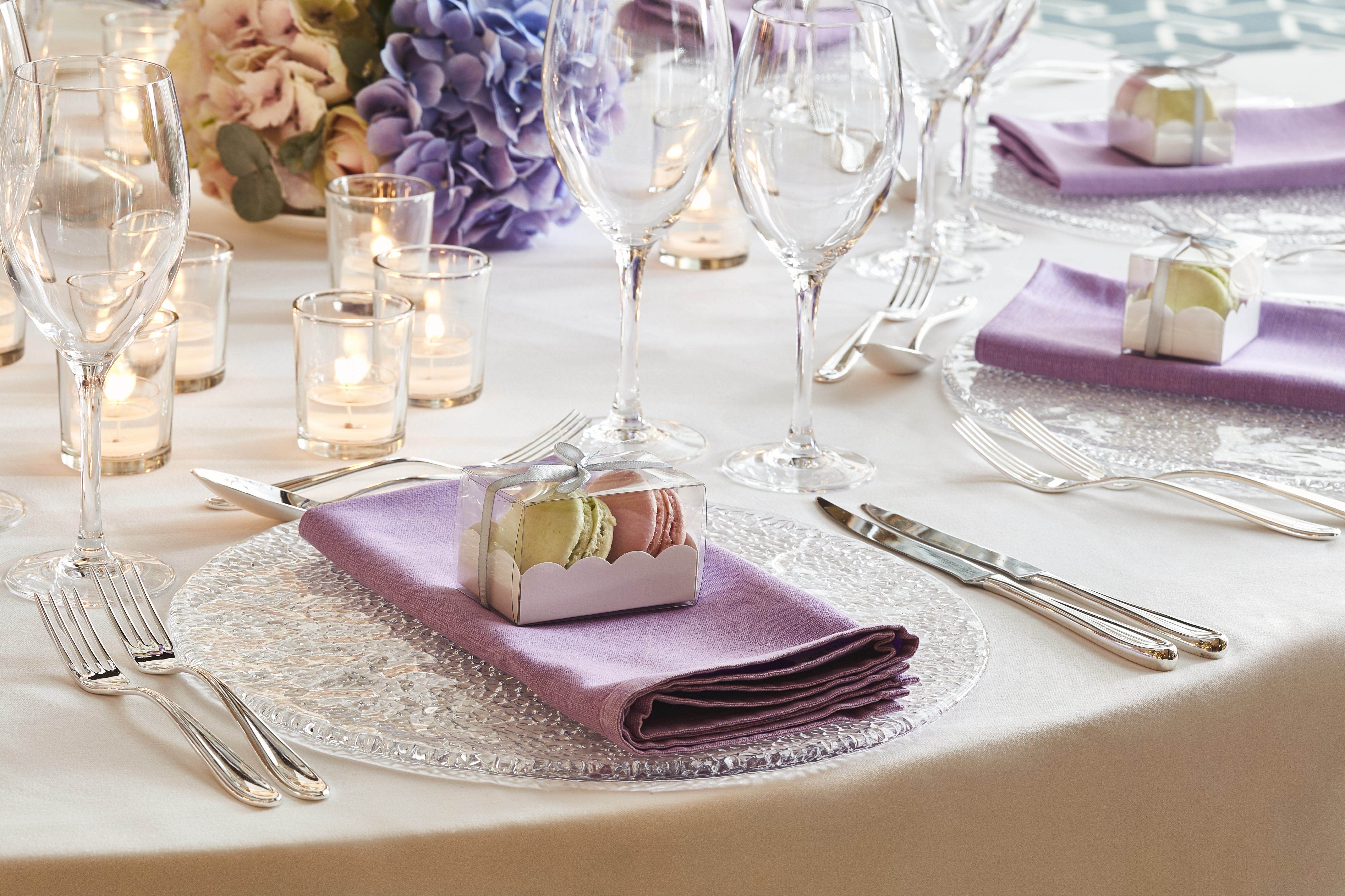 Elegant dining table with lavender napkins for weddings and upscale events.