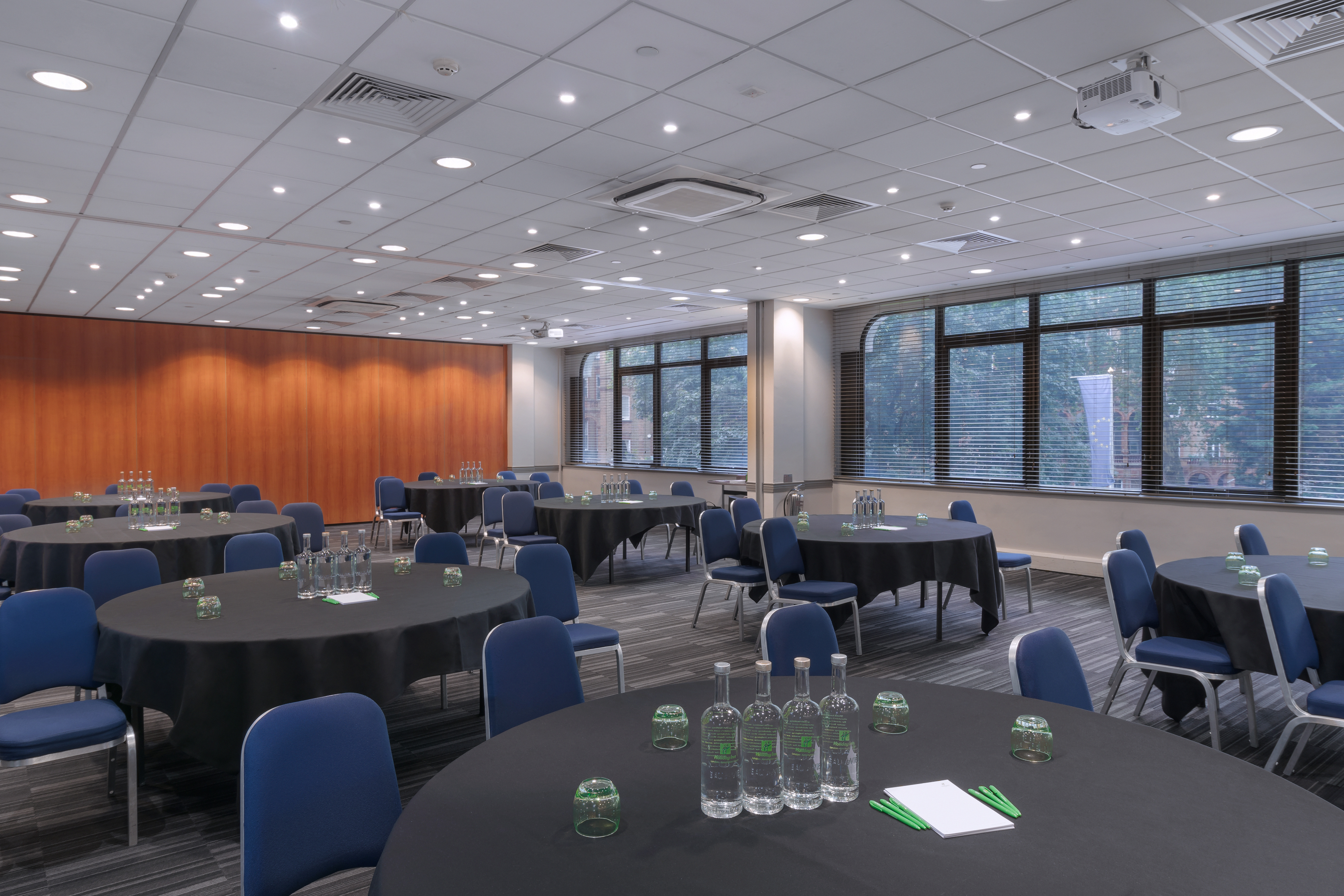 Versatile meeting space with round tables for workshops and seminars in London.