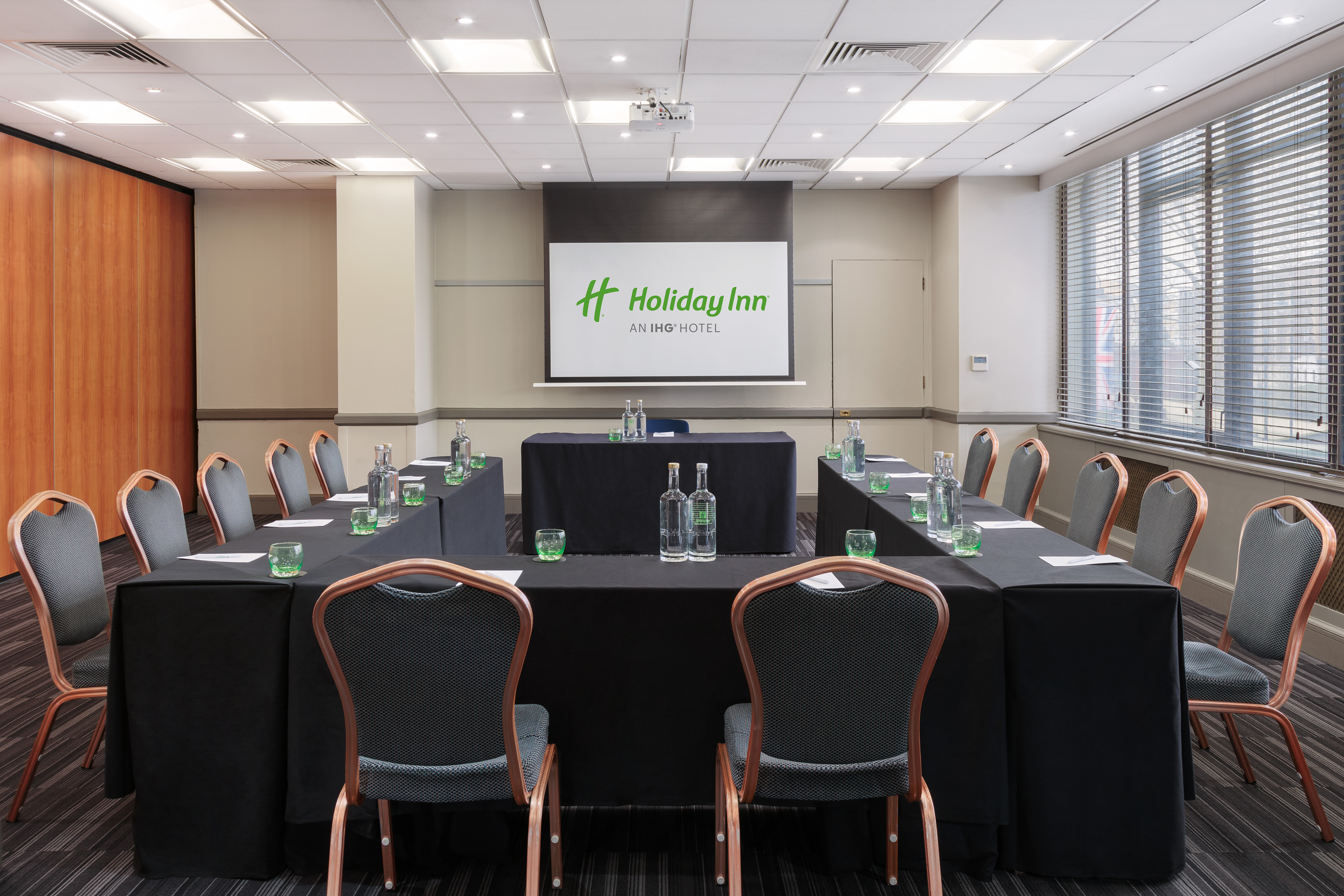 Hockney in a corporate meeting room with U-shaped tables at Holiday Inn Kensington.