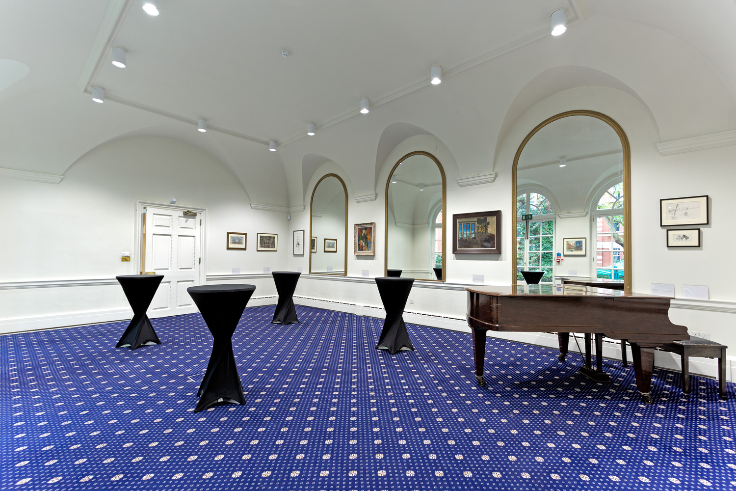 Elegant event space with grand piano, ideal for networking and receptions at Imperial Venues.