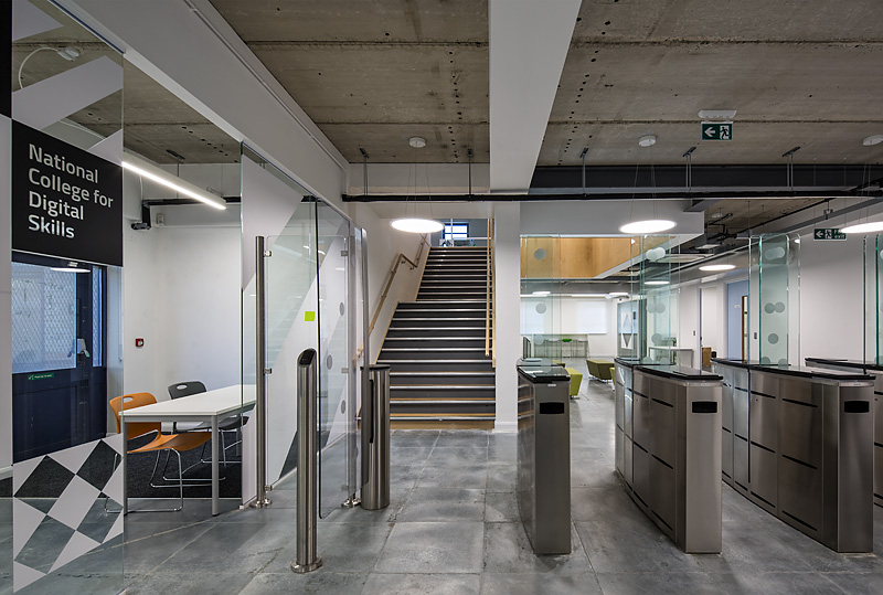 Modern meeting room with glass partitions at Ada National College for events and workshops.