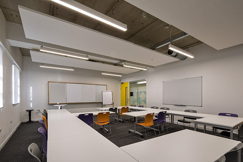 Modern classroom with flexible seating for workshops at Ada National College.