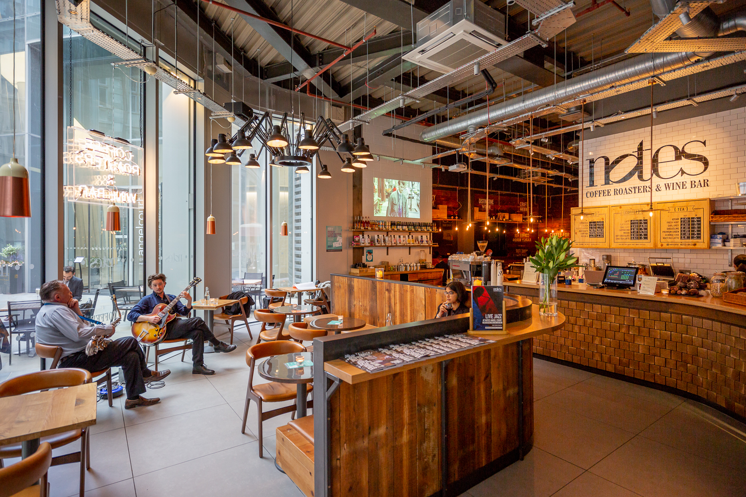 Modern café with warm lighting, ideal for networking events and informal meetings.