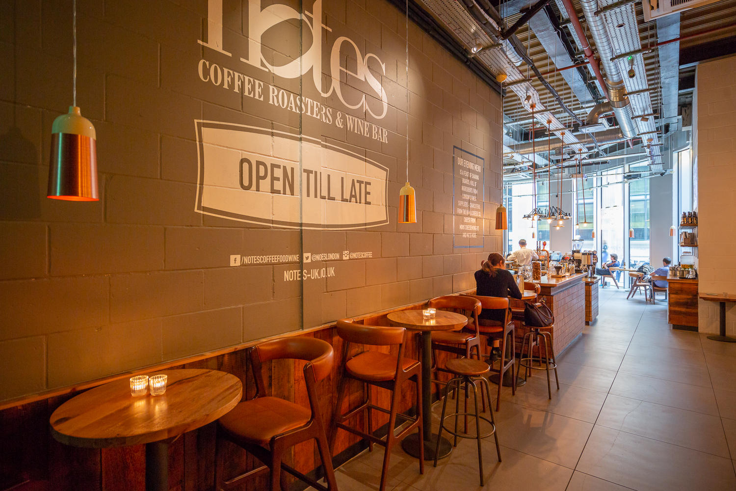 Modern coffee shop with cozy seating, perfect for networking events and casual meetups.