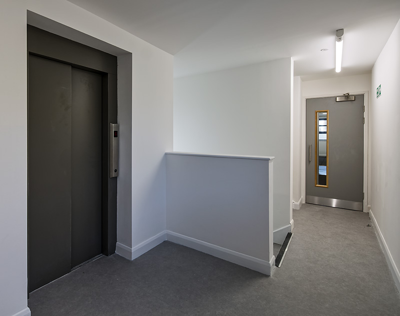 Modern corridor with elevator at Ada National College for Digital Skills, ideal for events.